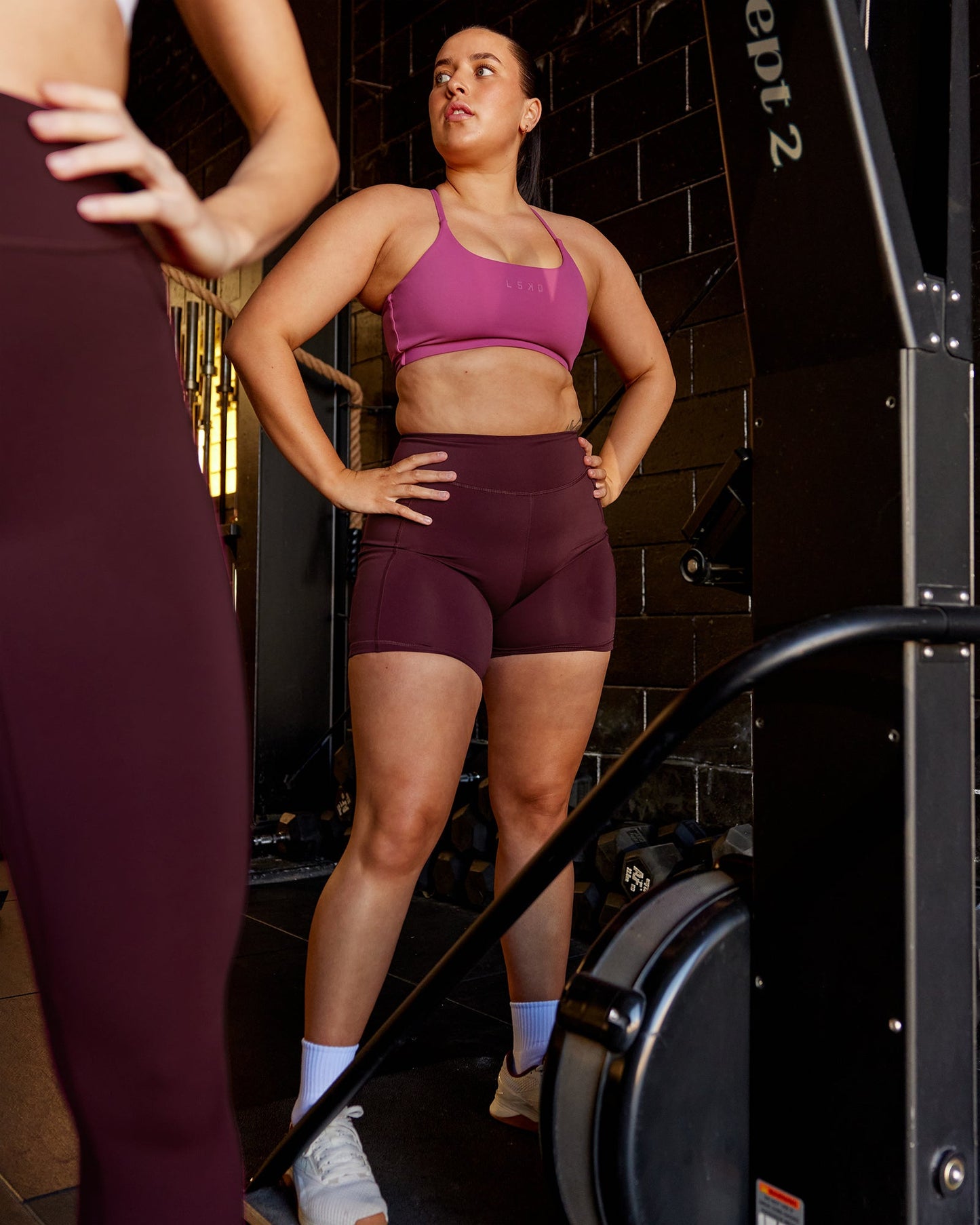 Woman wearing Elite Mid-Length Shorts - Dark Cherry