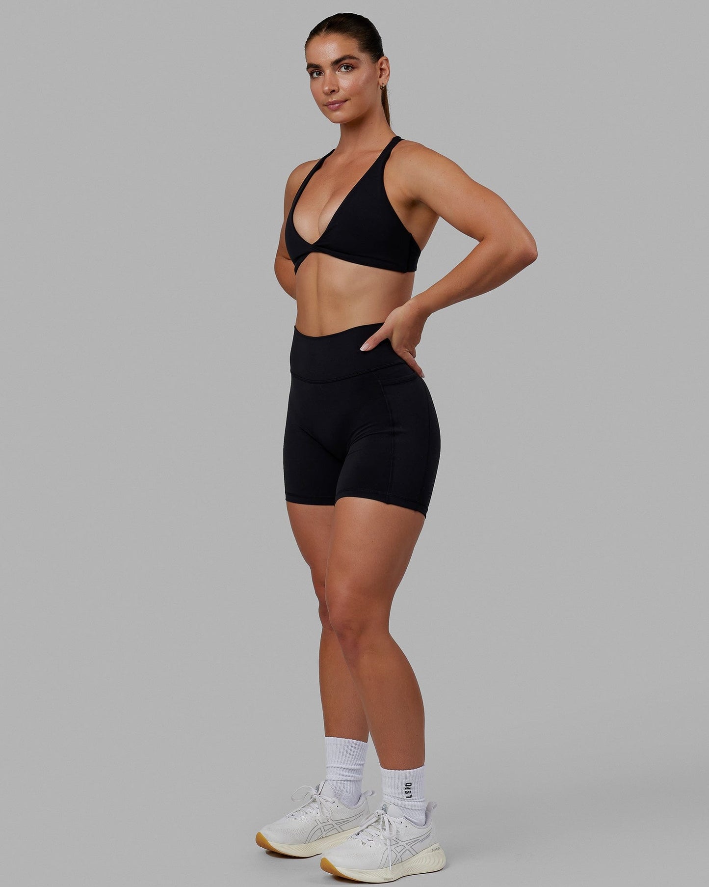 Woman wearing Agile Sports Bra - Black