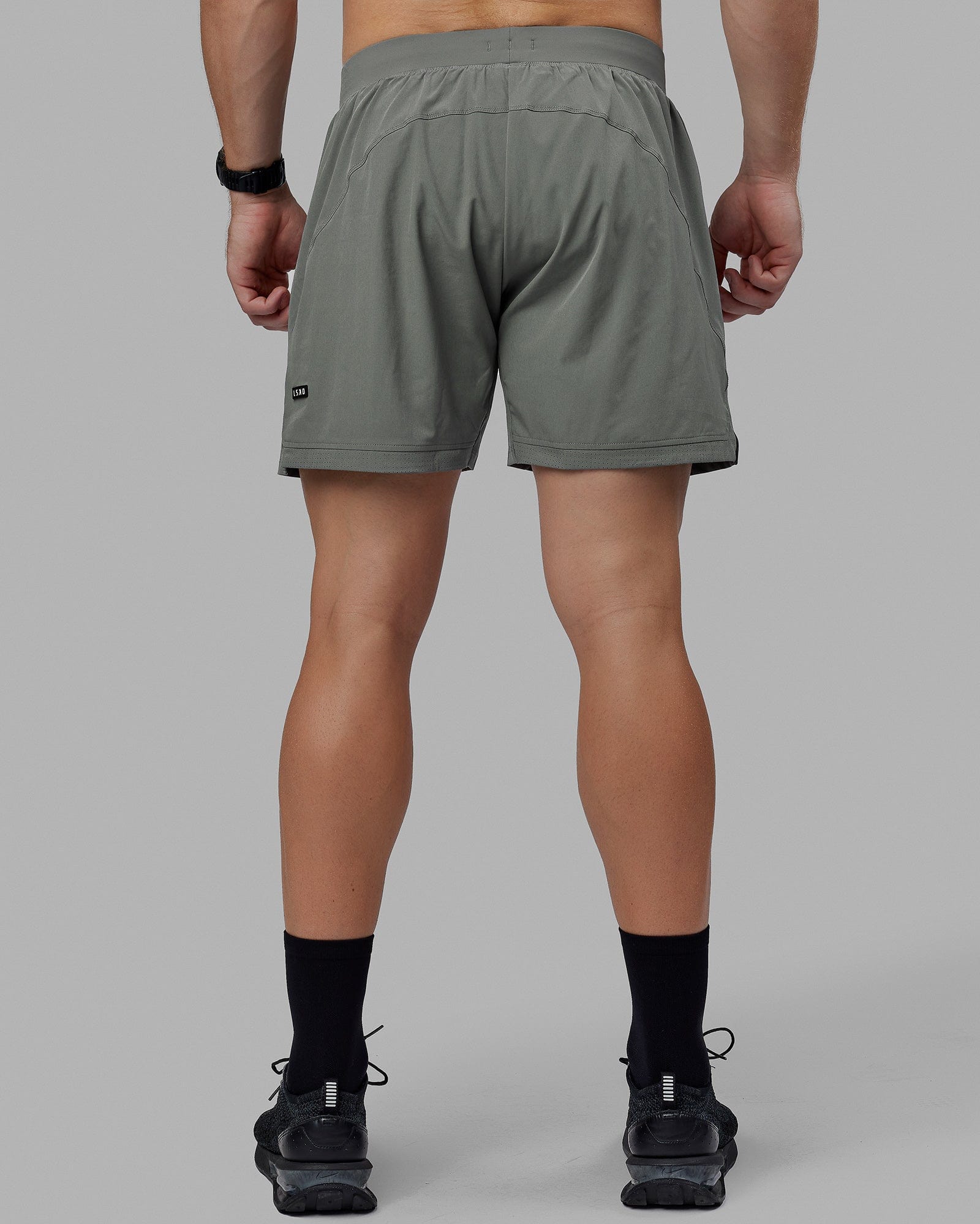 Man wearing Challenger 6" Lined Performance Shorts - Graphite