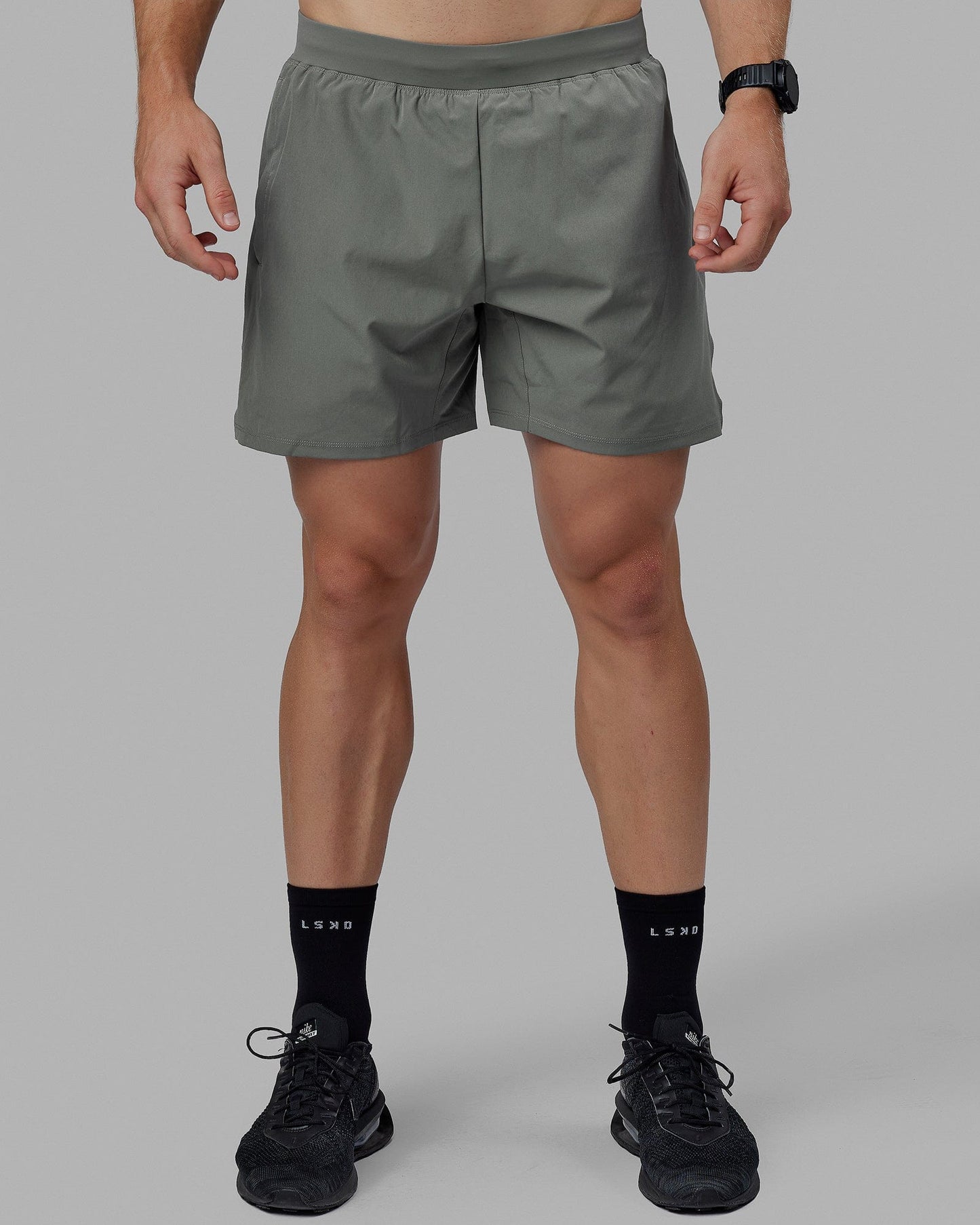 Man wearing Challenger 6" Lined Performance Shorts - Graphite