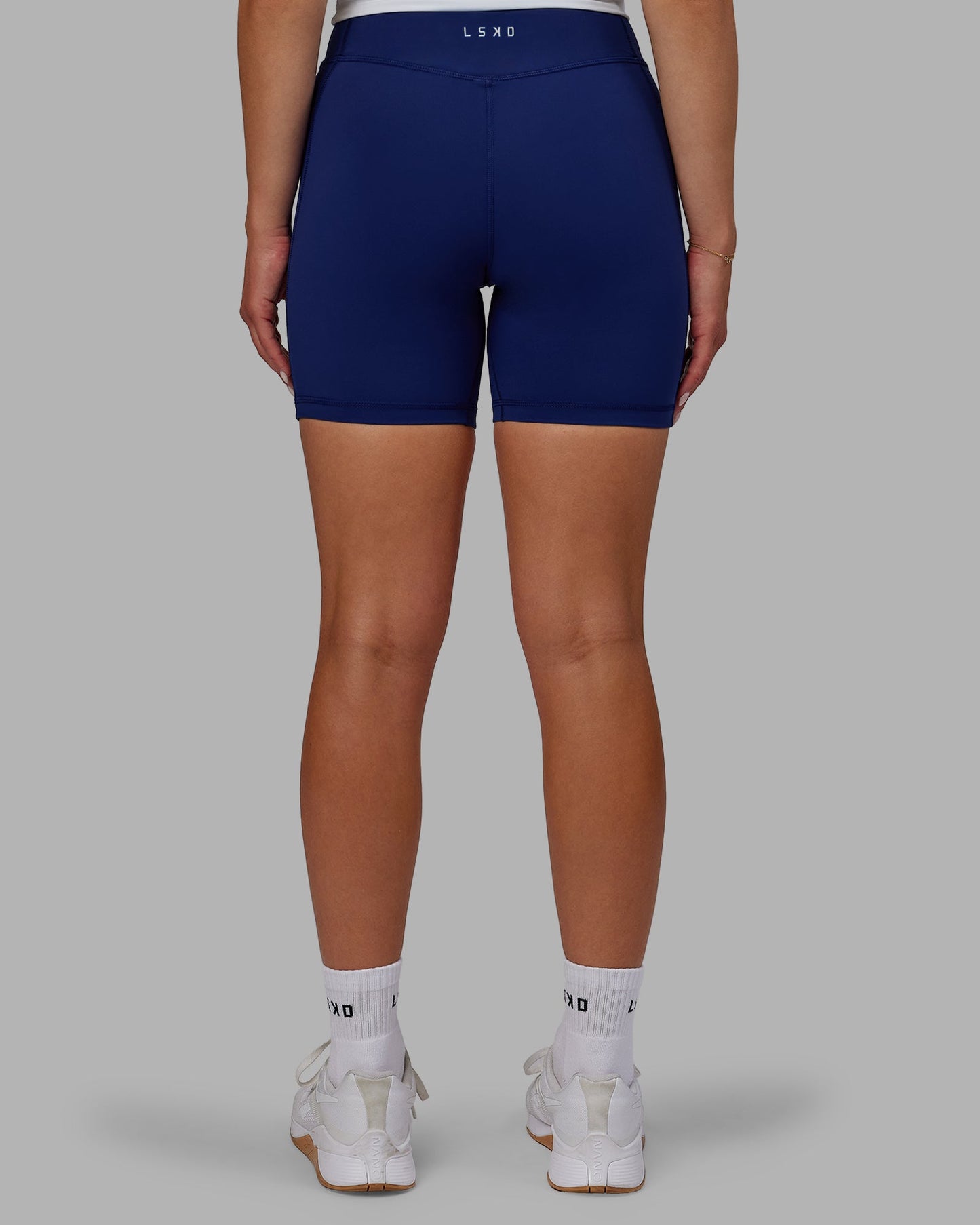 Woman wearing Elite Mid-Length Shorts - Midnight Blue