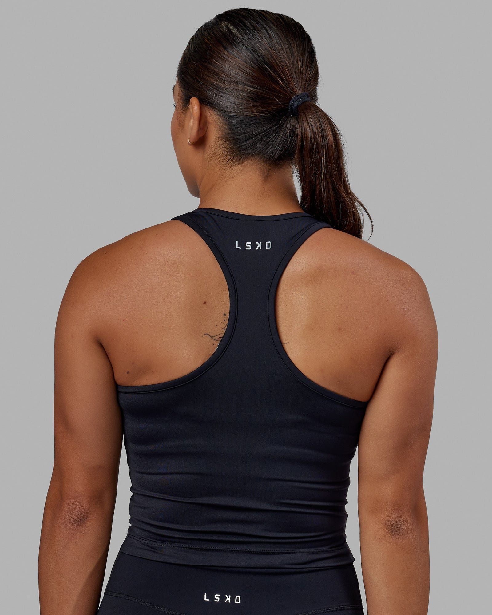 Woman wearing Flow Performance Tank - Black