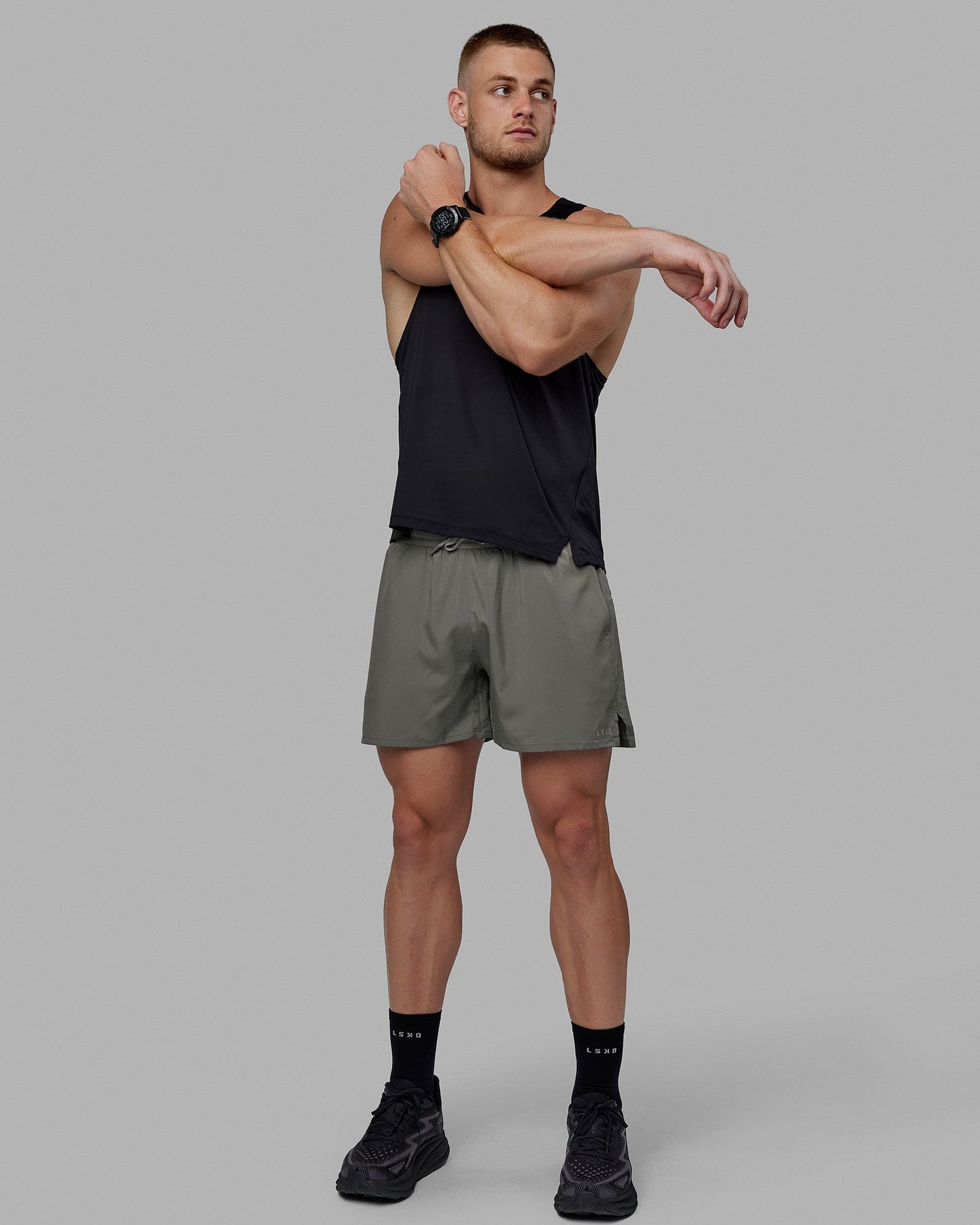 Man wearing Pace 5" Lined Performance Shorts - Graphite-Reflective