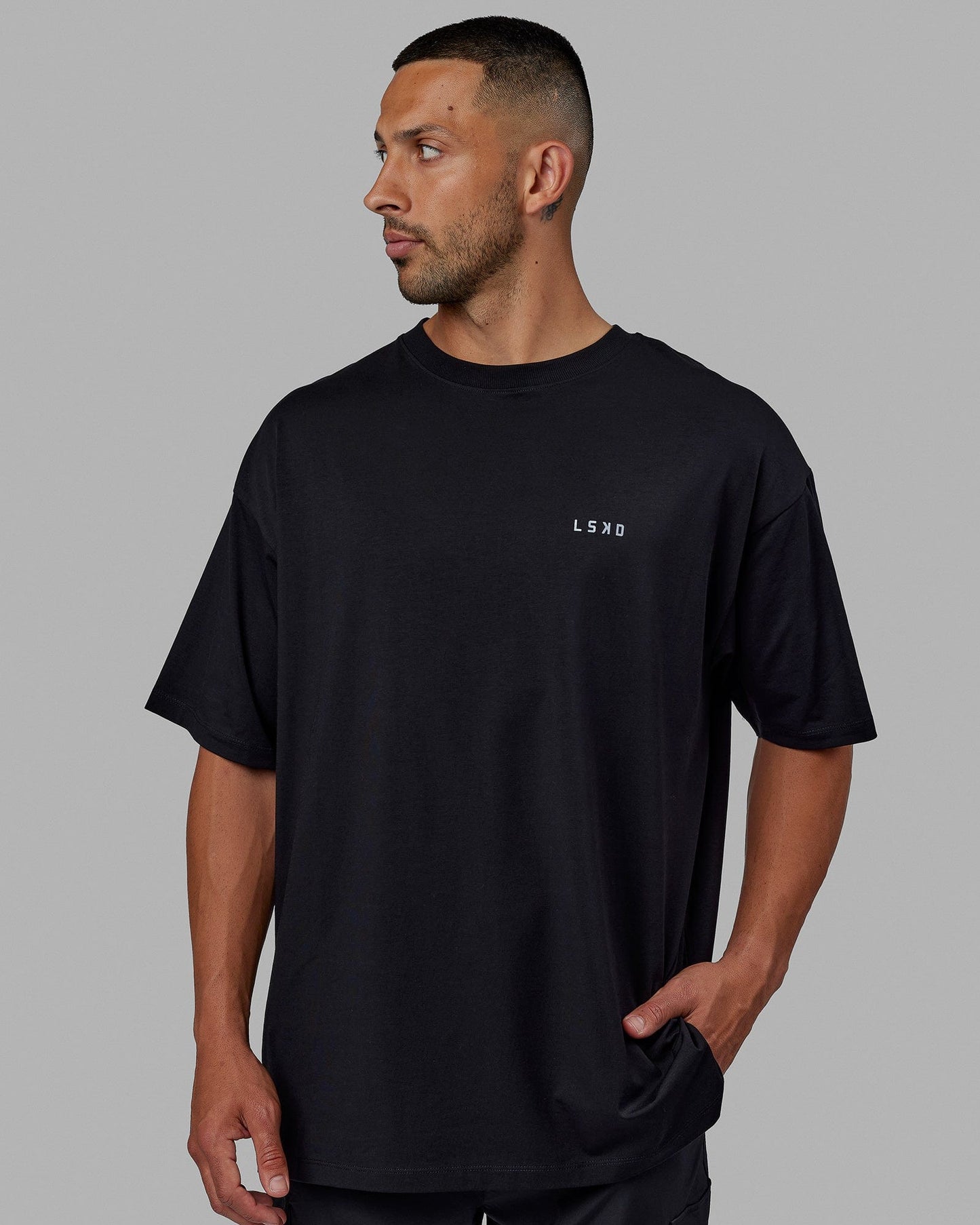 Man wearing Unisex PimaFLX Tee Oversize - Black