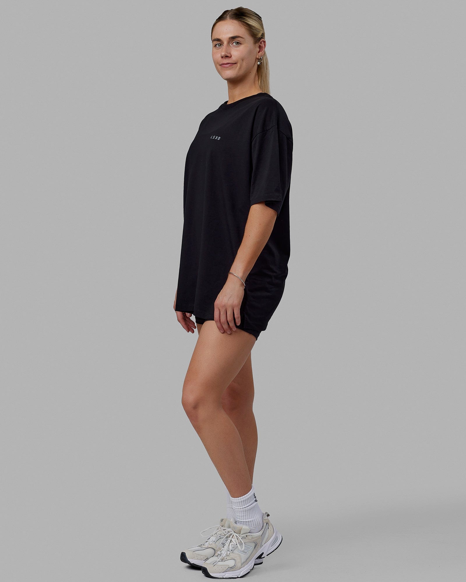 Woman wearing Unisex PimaFLX Tee Oversize - Black