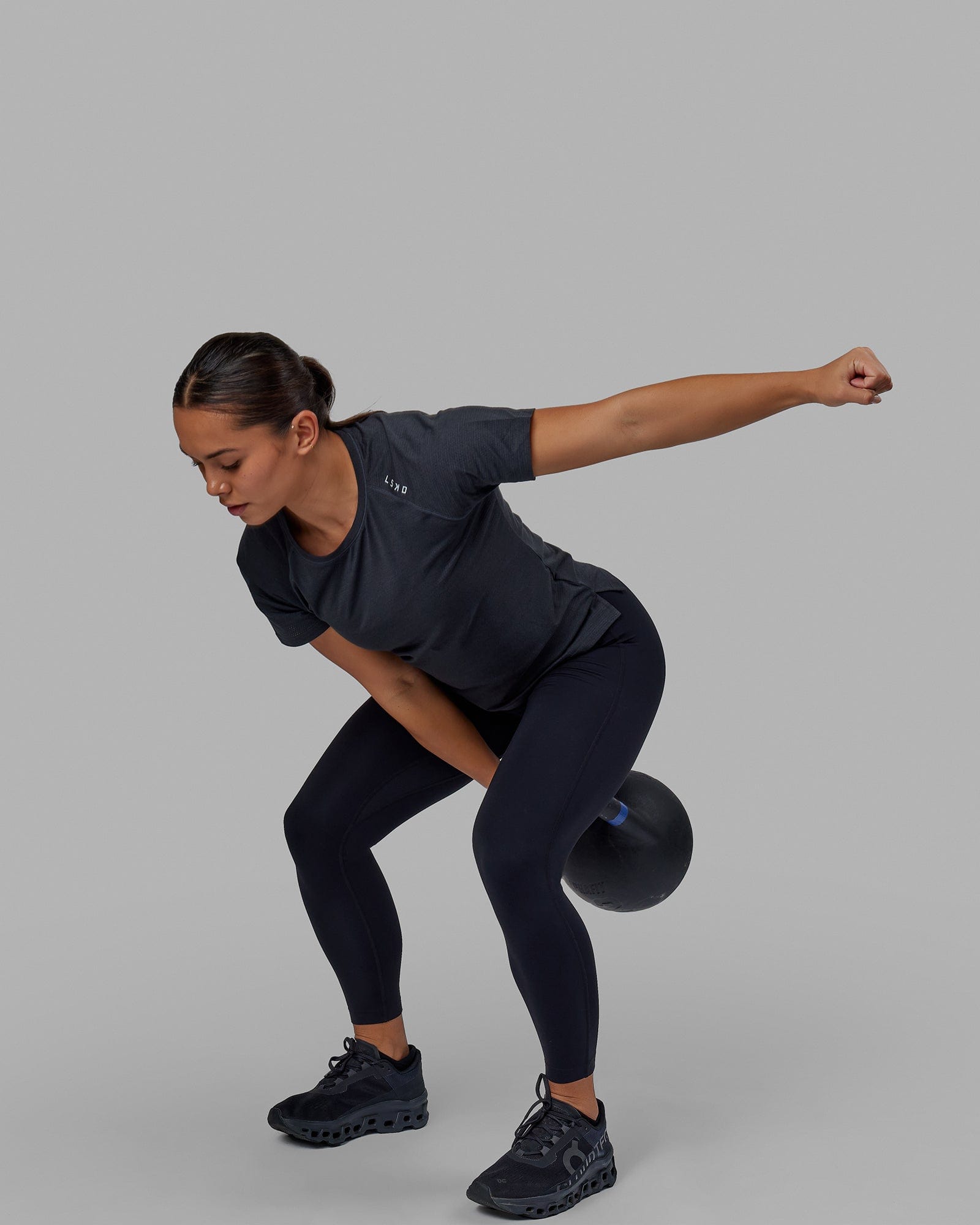 Woman wearing Perform VapourFLX Tee - Black Marl