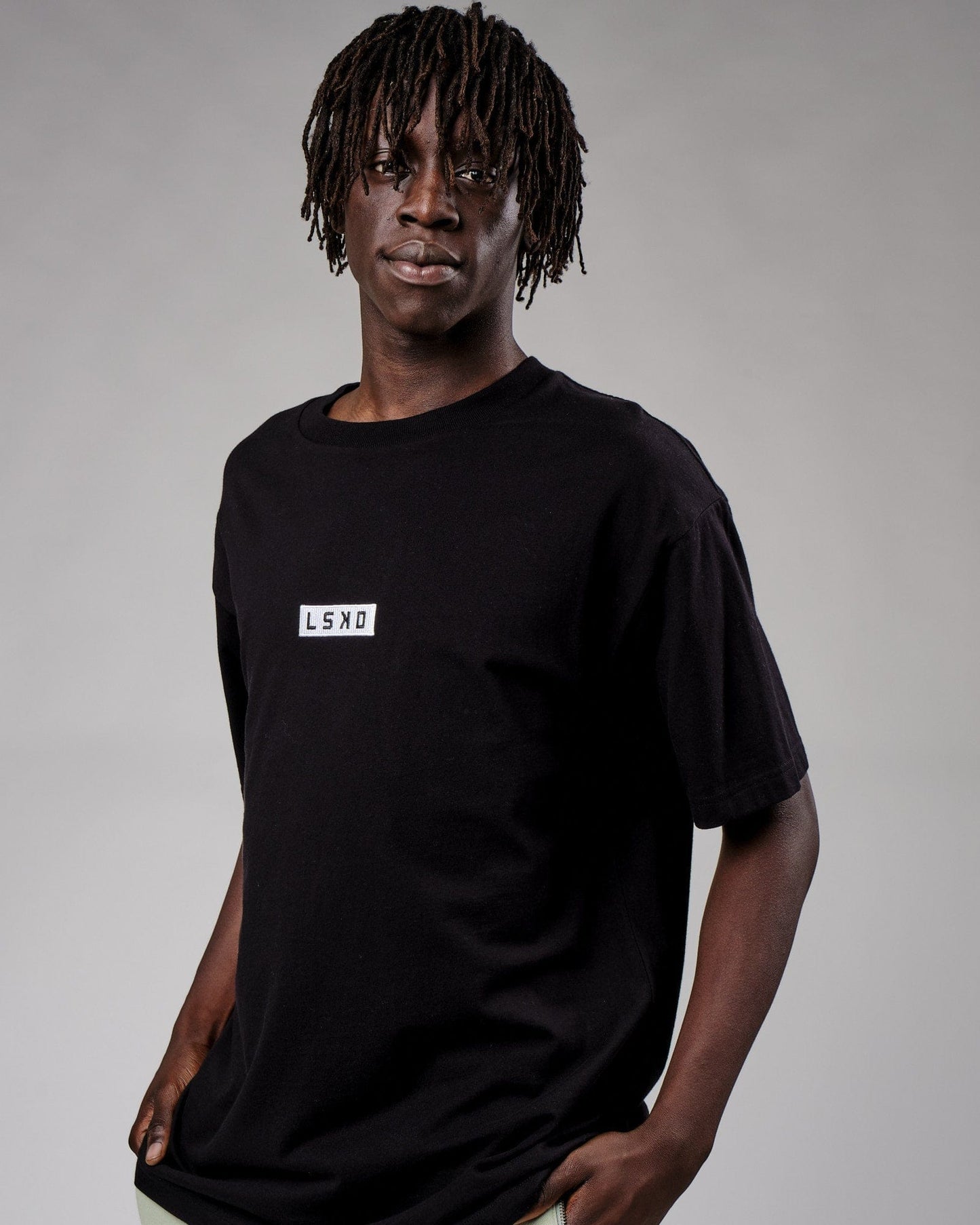Model wearing Cornerstone Tee Oversize - Black