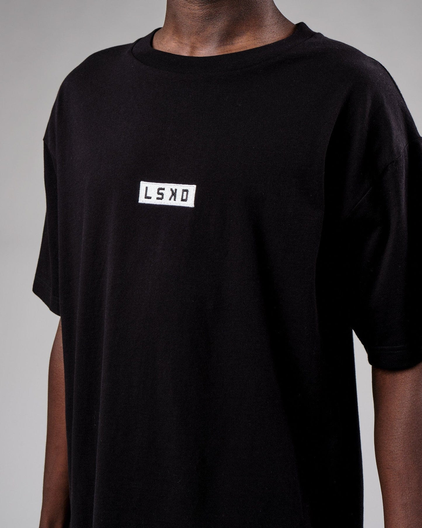 Model wearing Cornerstone Tee Oversize - Black