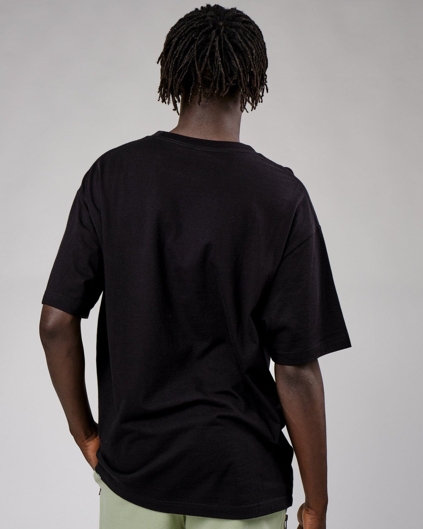 Model wearing Cornerstone Tee Oversize - Black