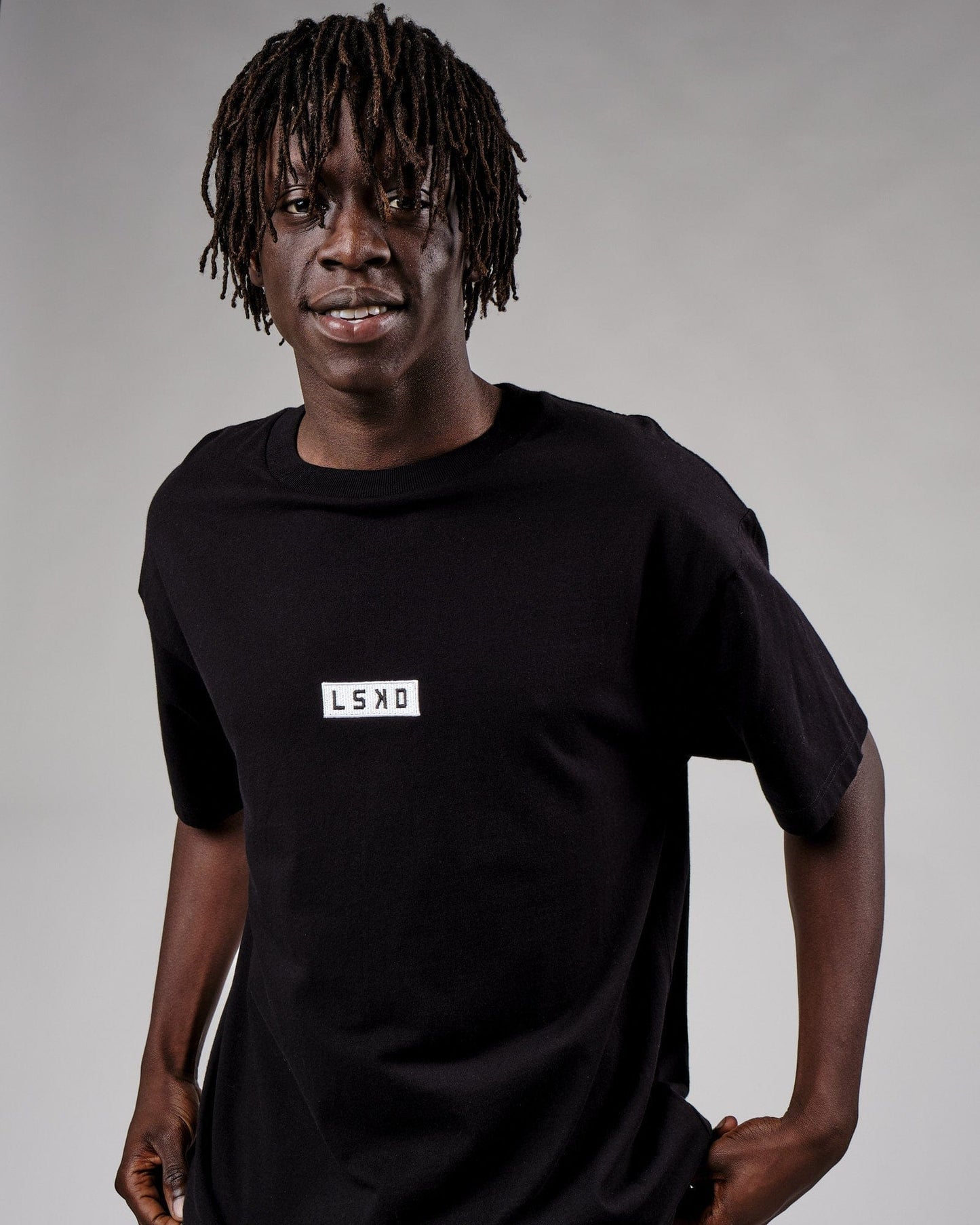 Model wearing Cornerstone Tee Oversize - Black