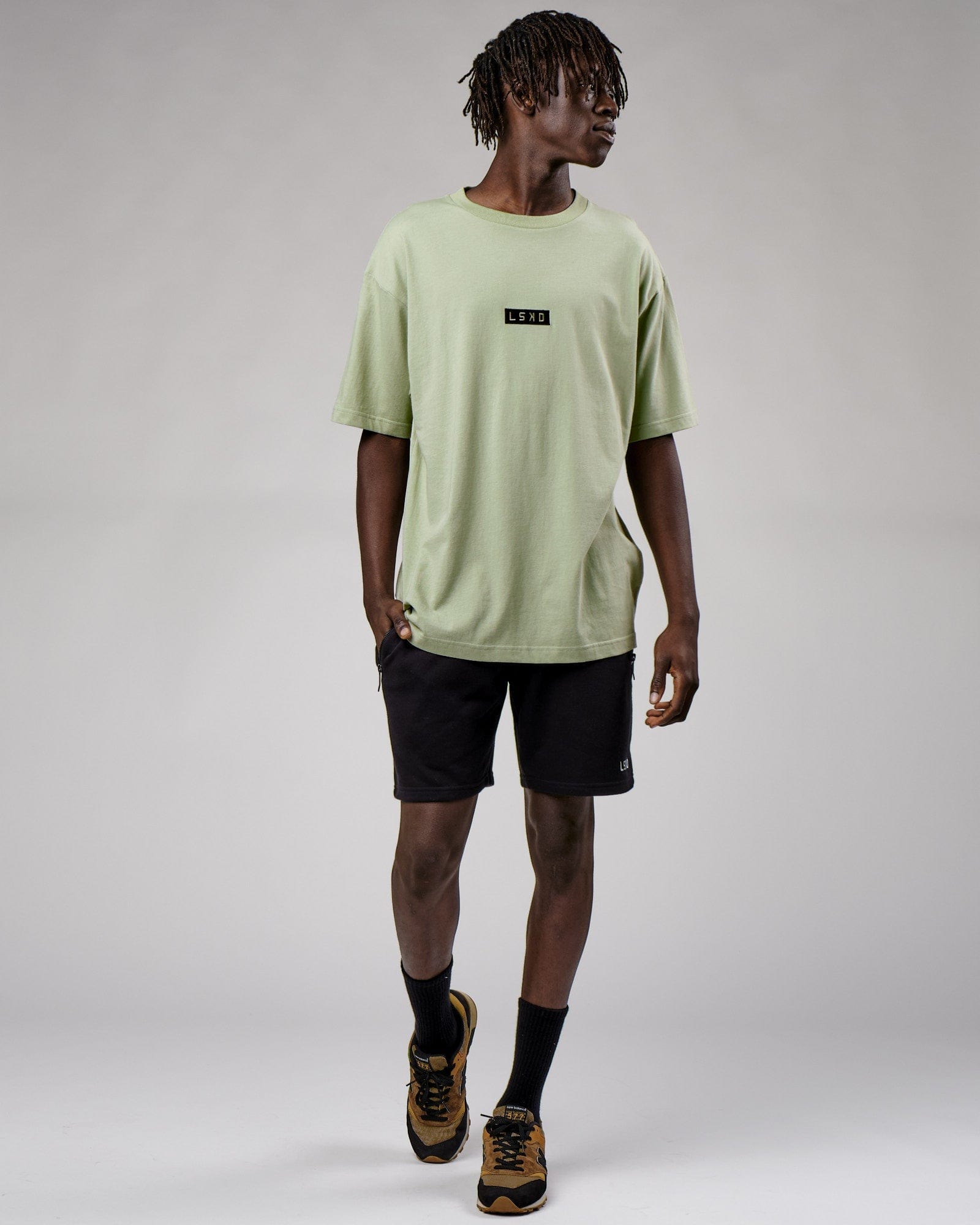Model wearing Cornerstone Tee Oversize - Desert Sage