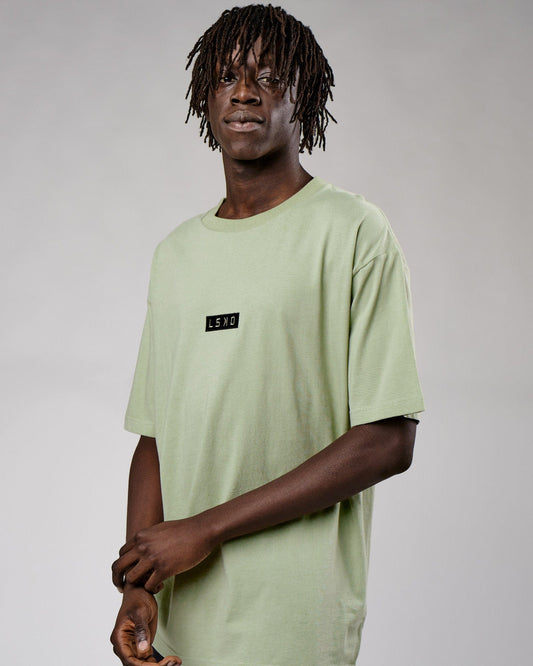 Model wearing Cornerstone Tee Oversize - Desert Sage