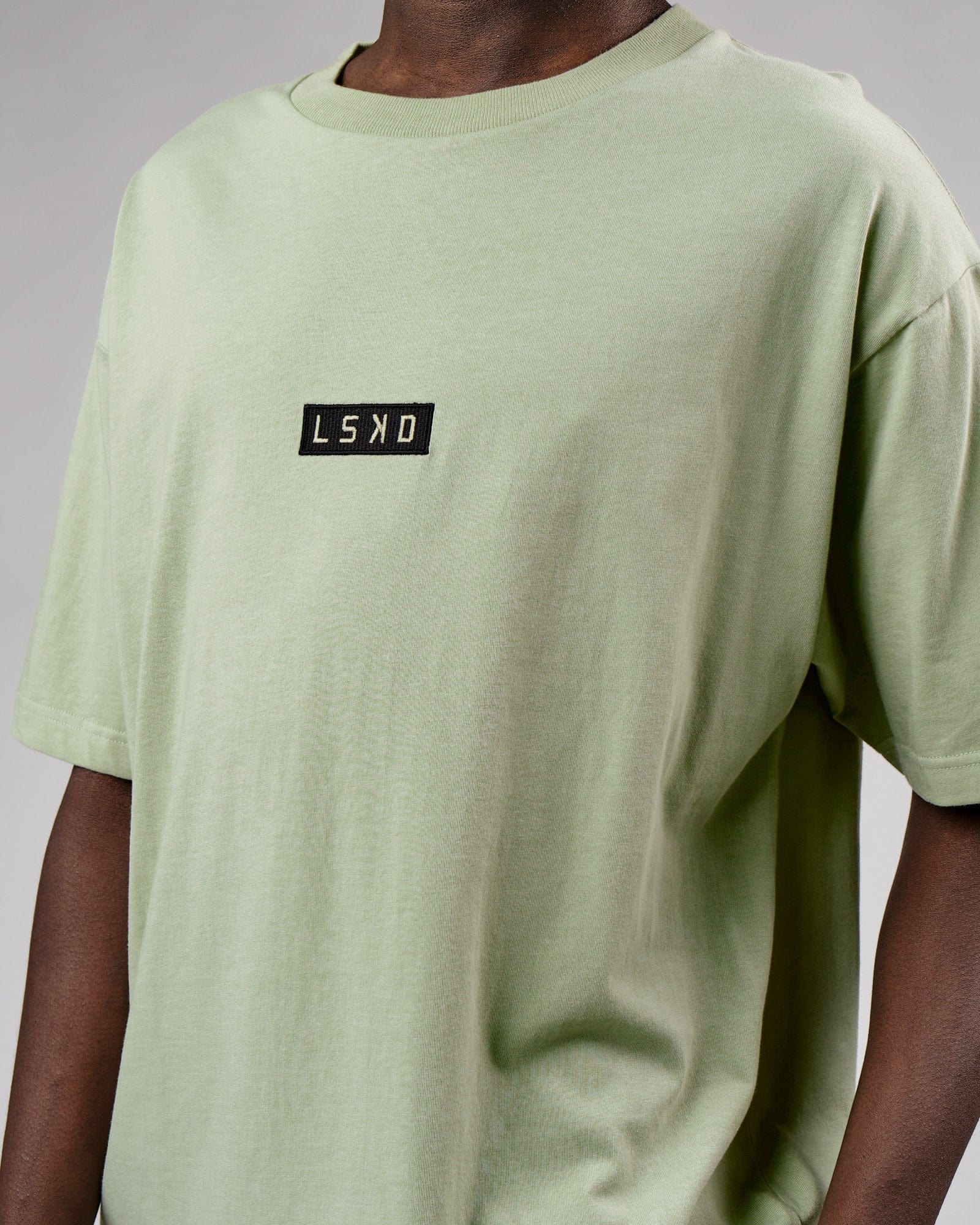 Model wearing Cornerstone Tee Oversize - Desert Sage