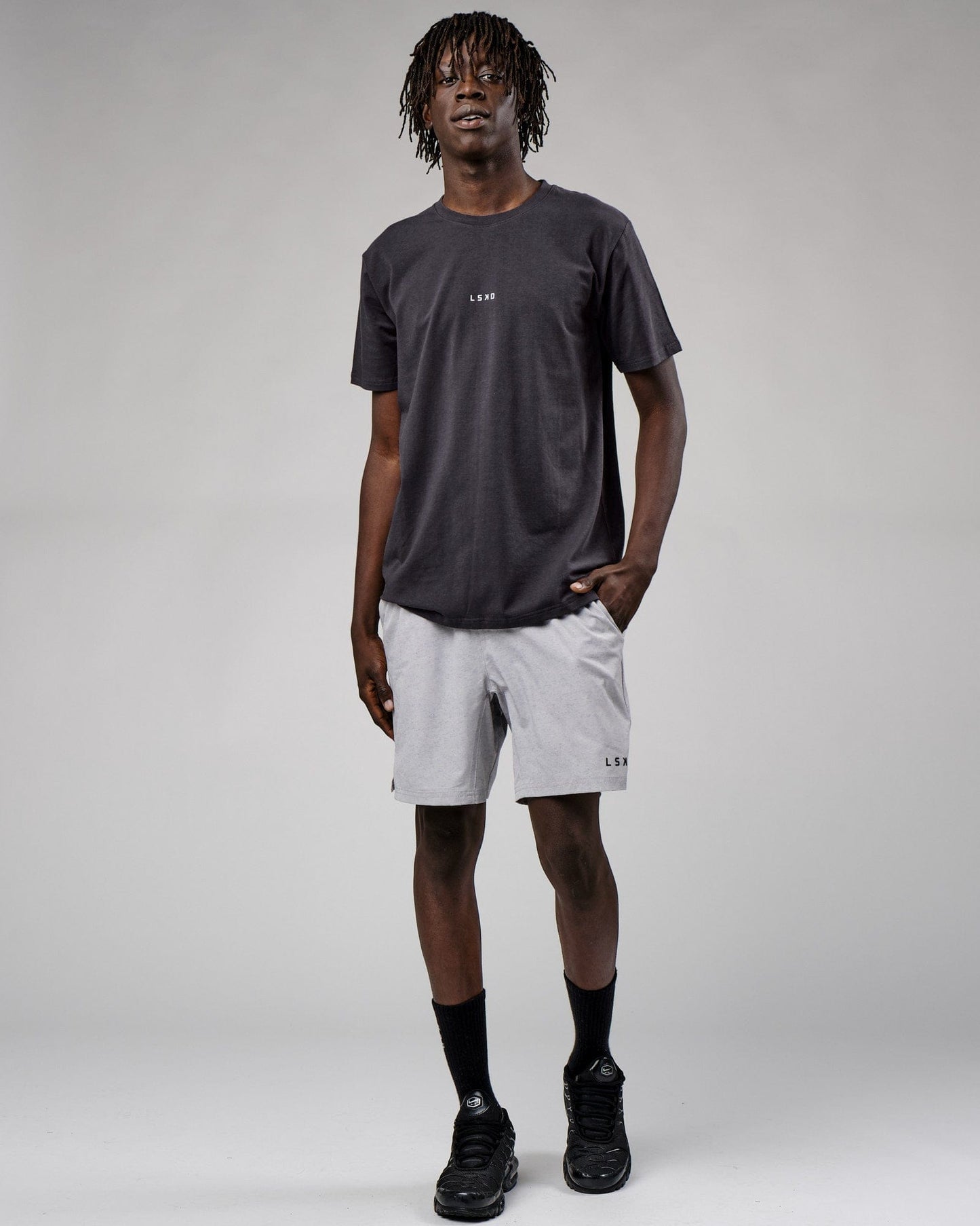 Model wearing Base Tee - Phantom