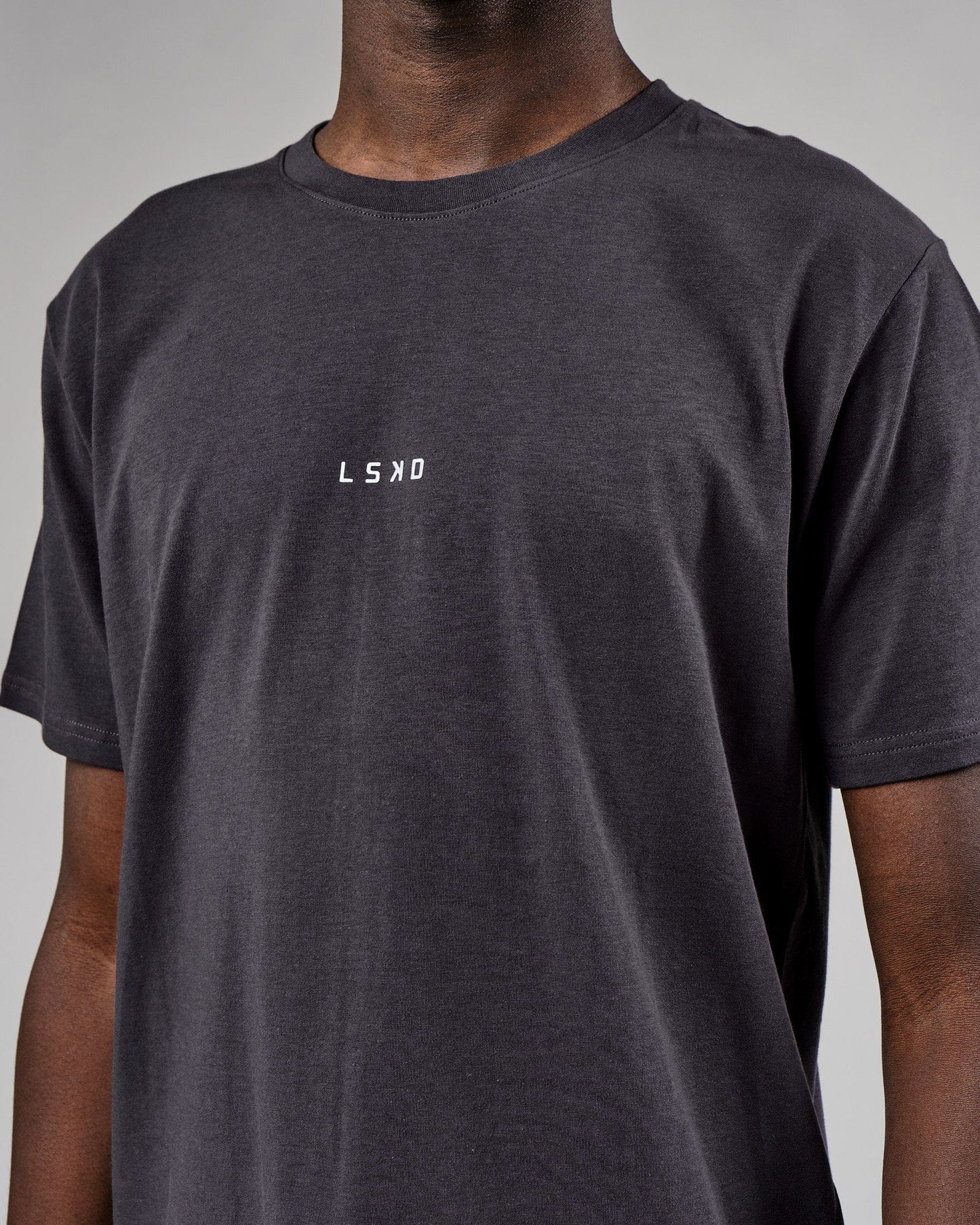 Model wearing Base Tee - Phantom