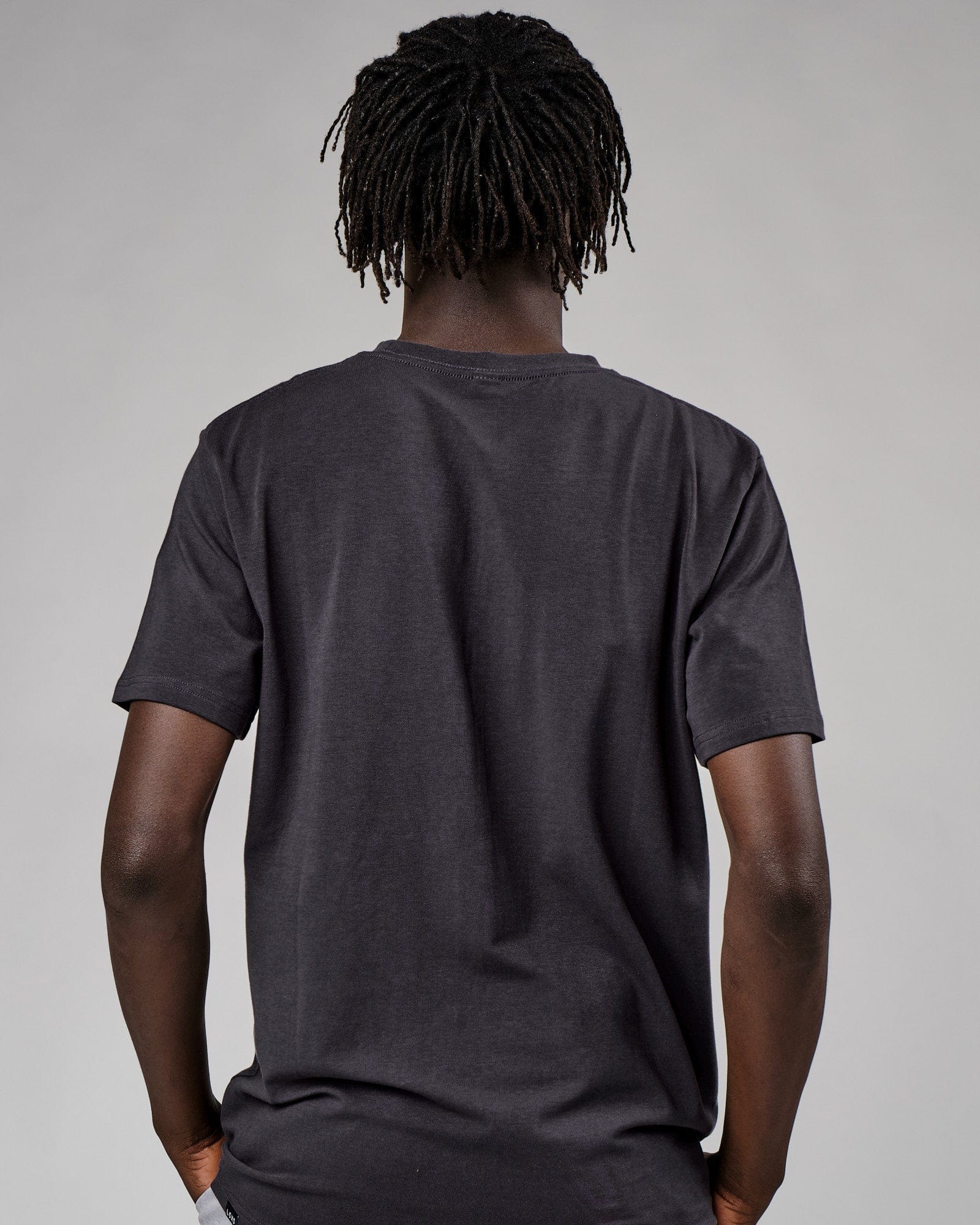 Model wearing Base Tee - Phantom