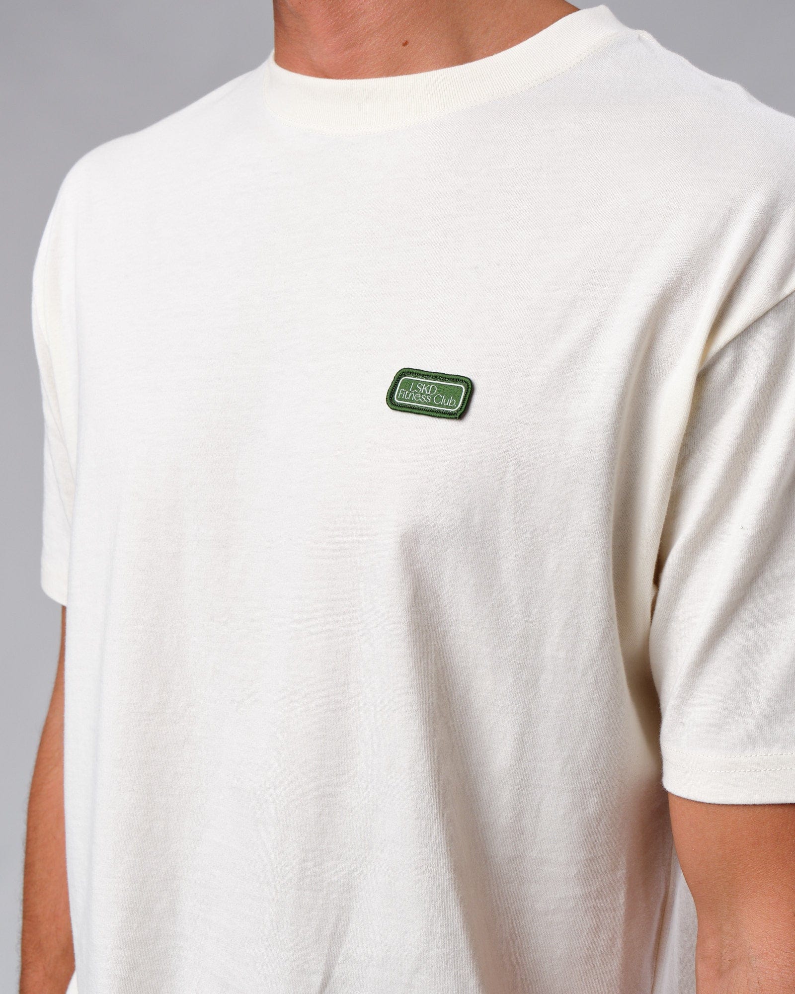 Model wearing Badge Tee Oversize - Cream