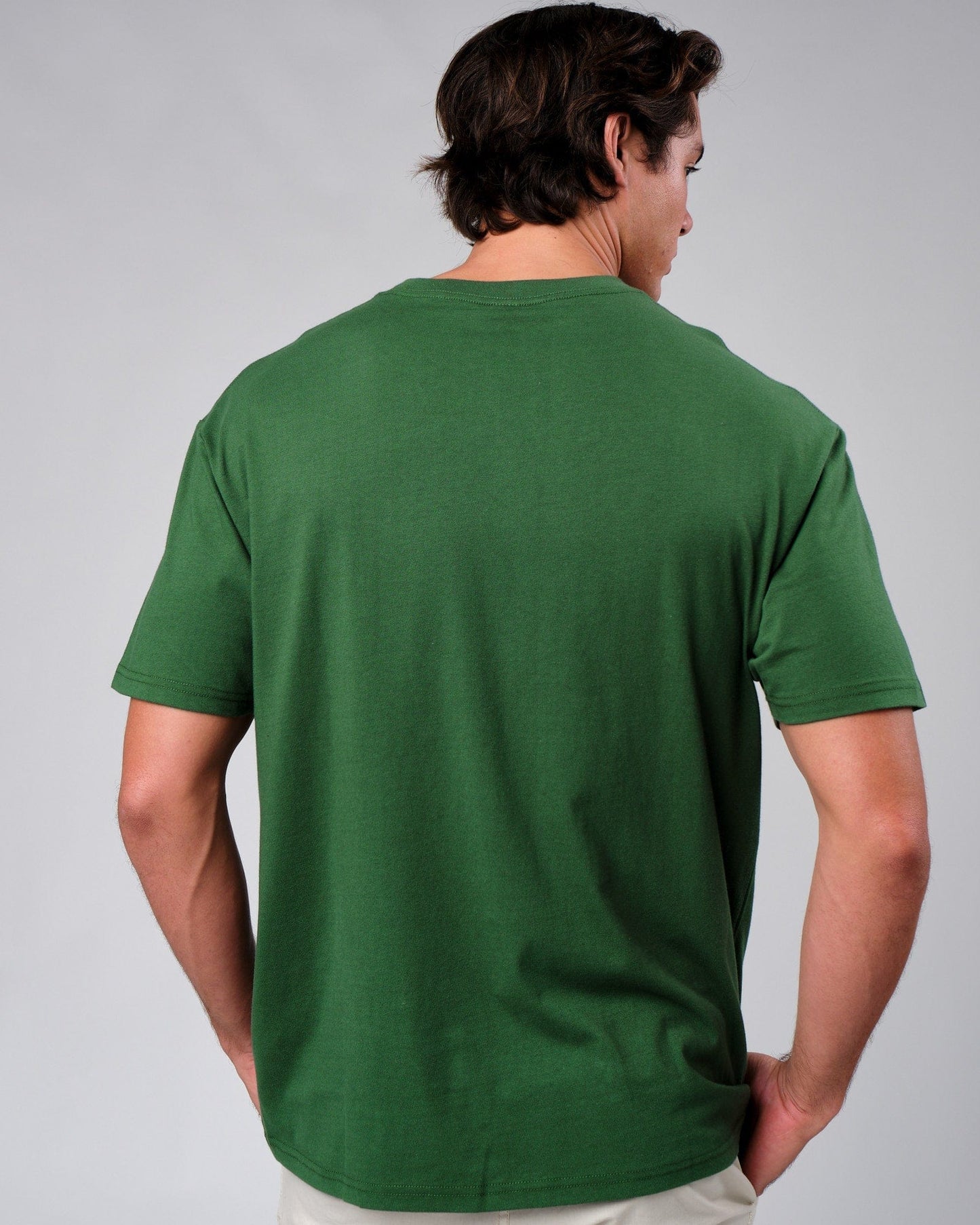 Model wearing Badge Tee Oversize - Eden Green