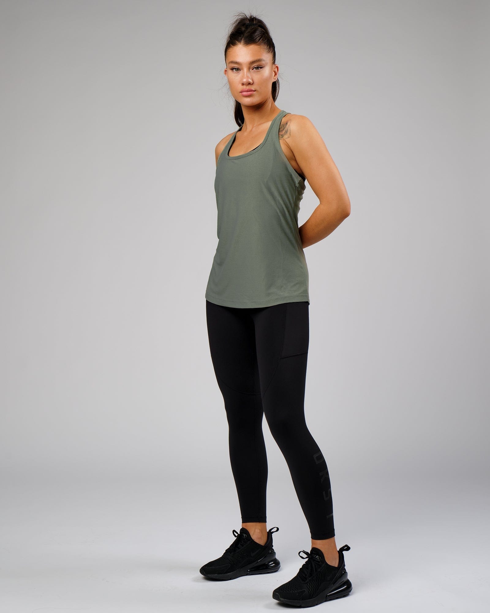 Model wearing Freedom Performance Tank - Dusty Olive