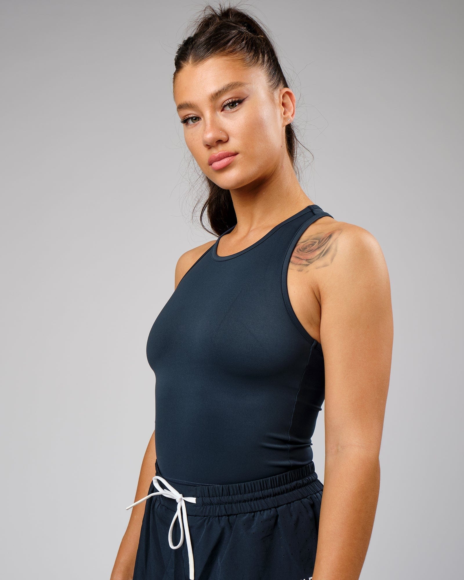 Model wearing Flow Performance Tank - Carbon