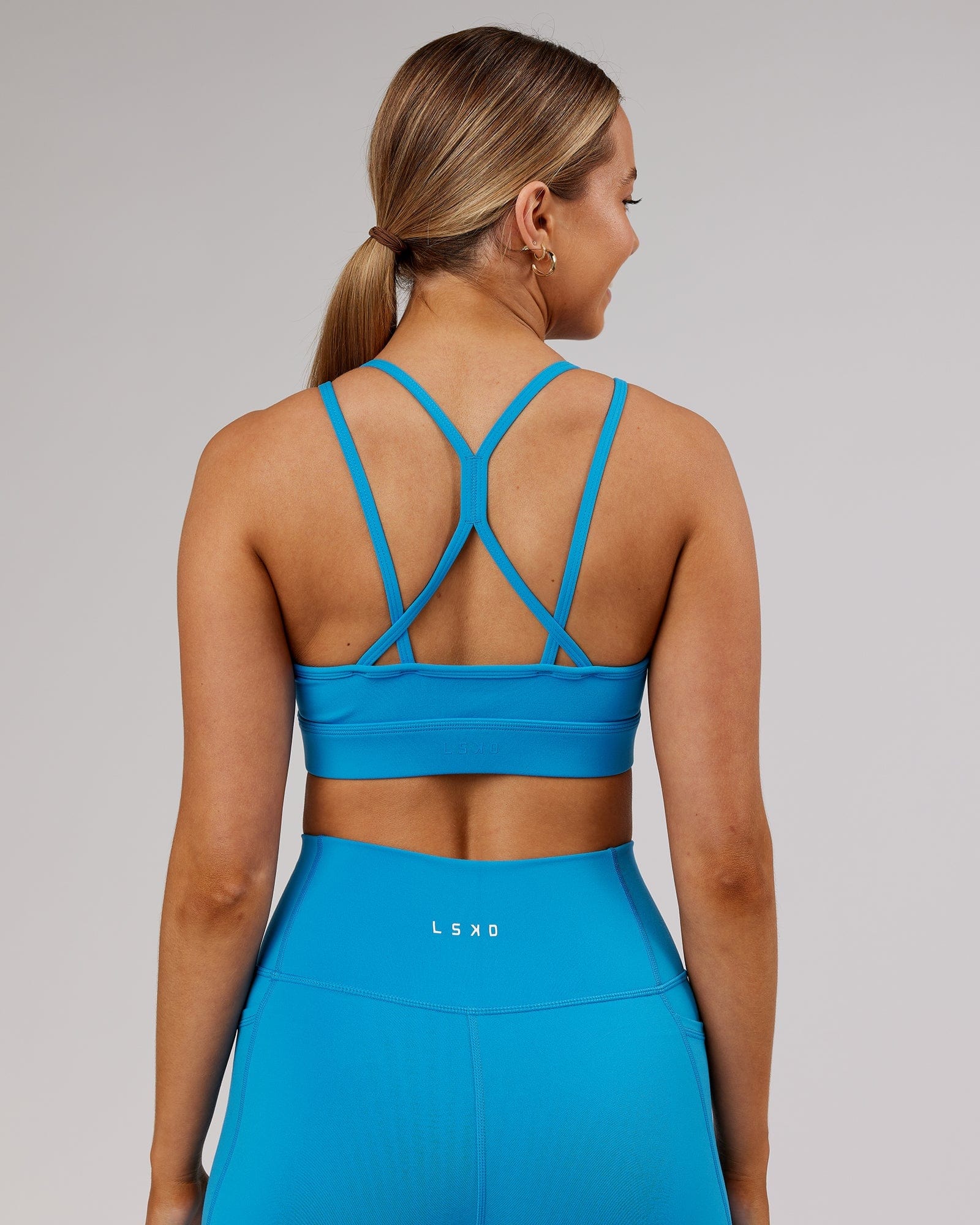 Model wearing Bridge Sports Bra - Ibiza Blue