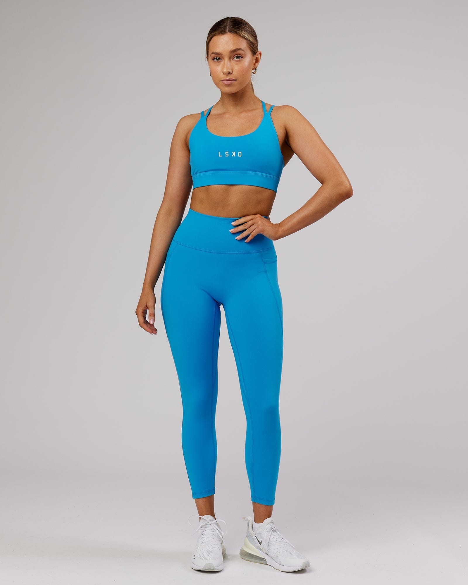 Model wearing Fusion 7/8 Length Tight - Ibiza Blue