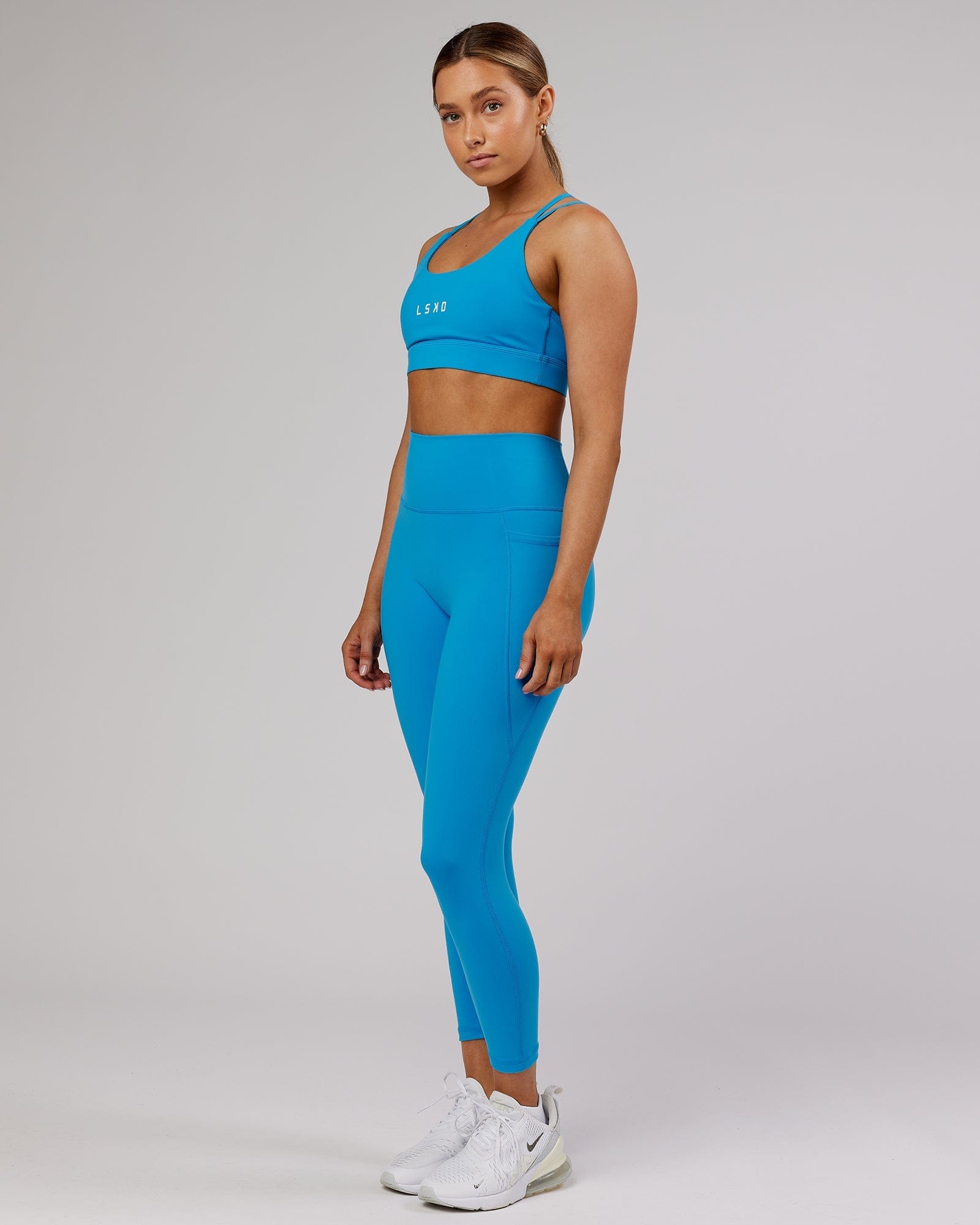 Model wearing Fusion 7/8 Length Tight - Ibiza Blue