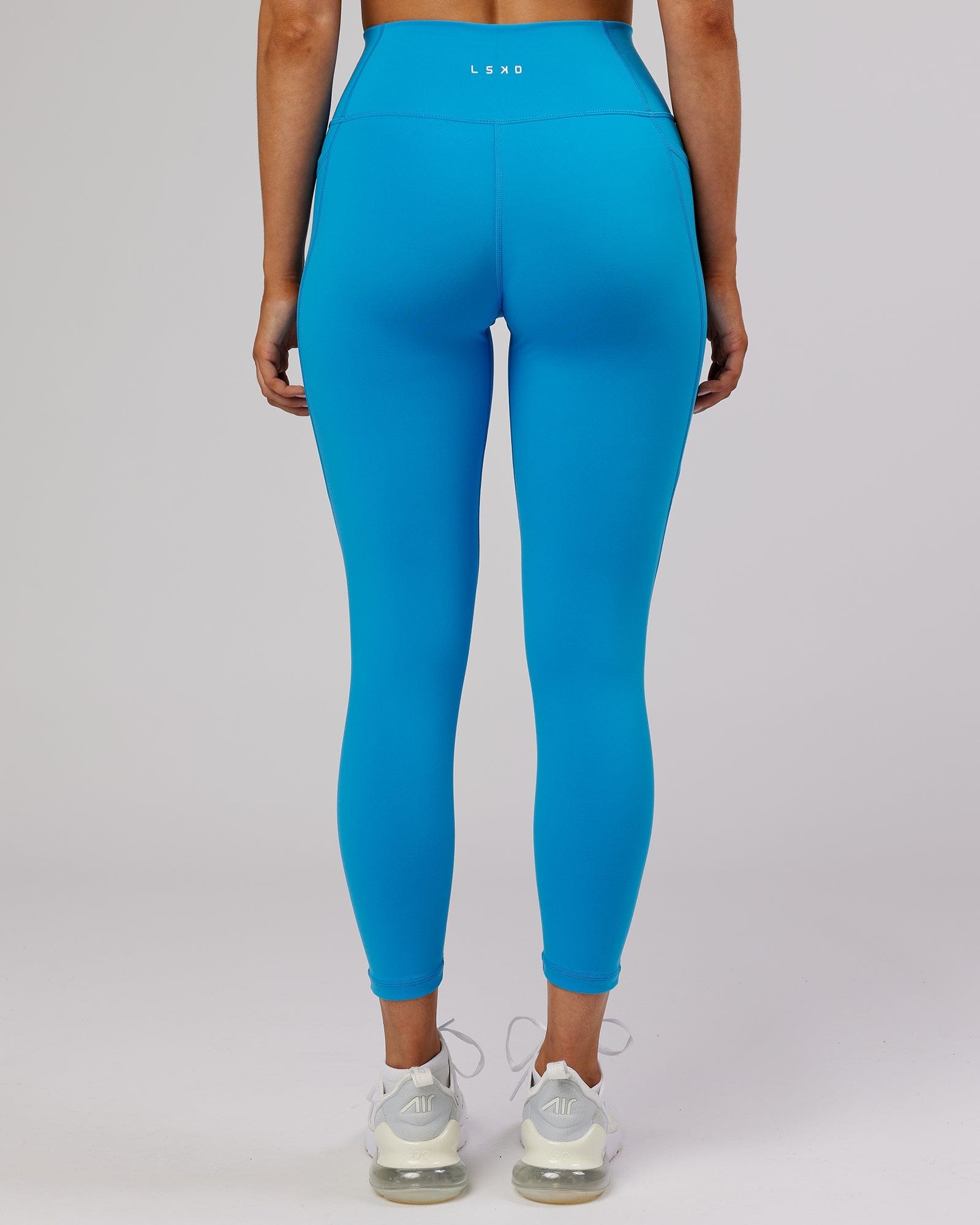 Model wearing Fusion 7/8 Length Tight - Ibiza Blue