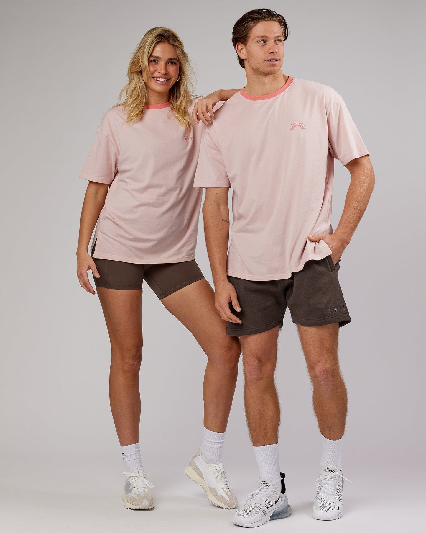 Model wearing Unisex Rise FLXCotton Oversize Tee - Peach Flush