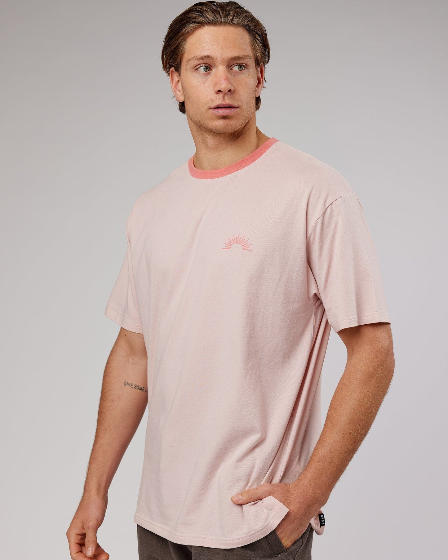 Model wearing Unisex Rise FLXCotton Oversize Tee - Peach Flush