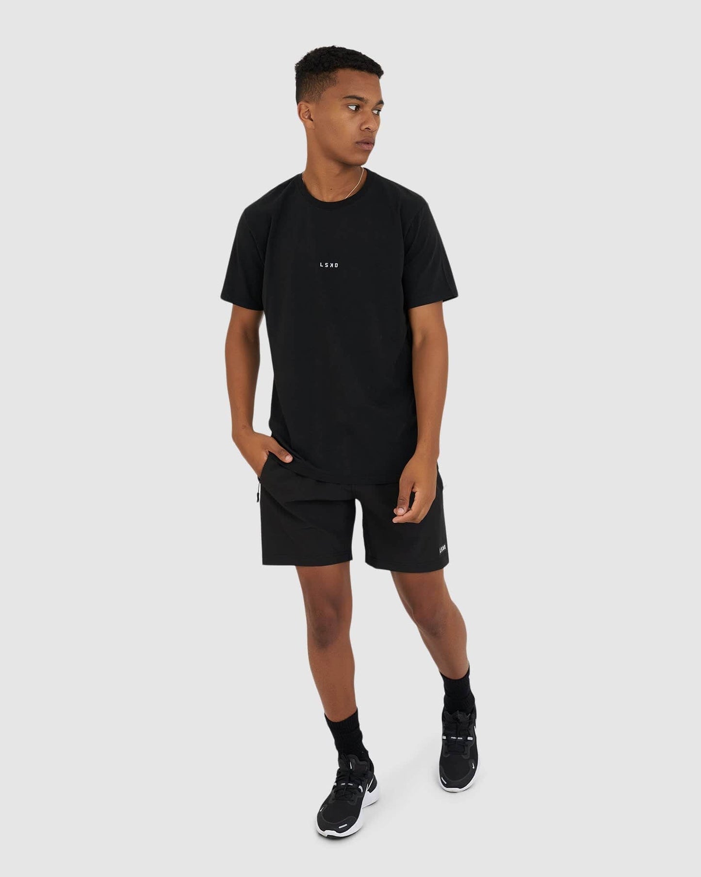 Model wearing Base Tee - Black