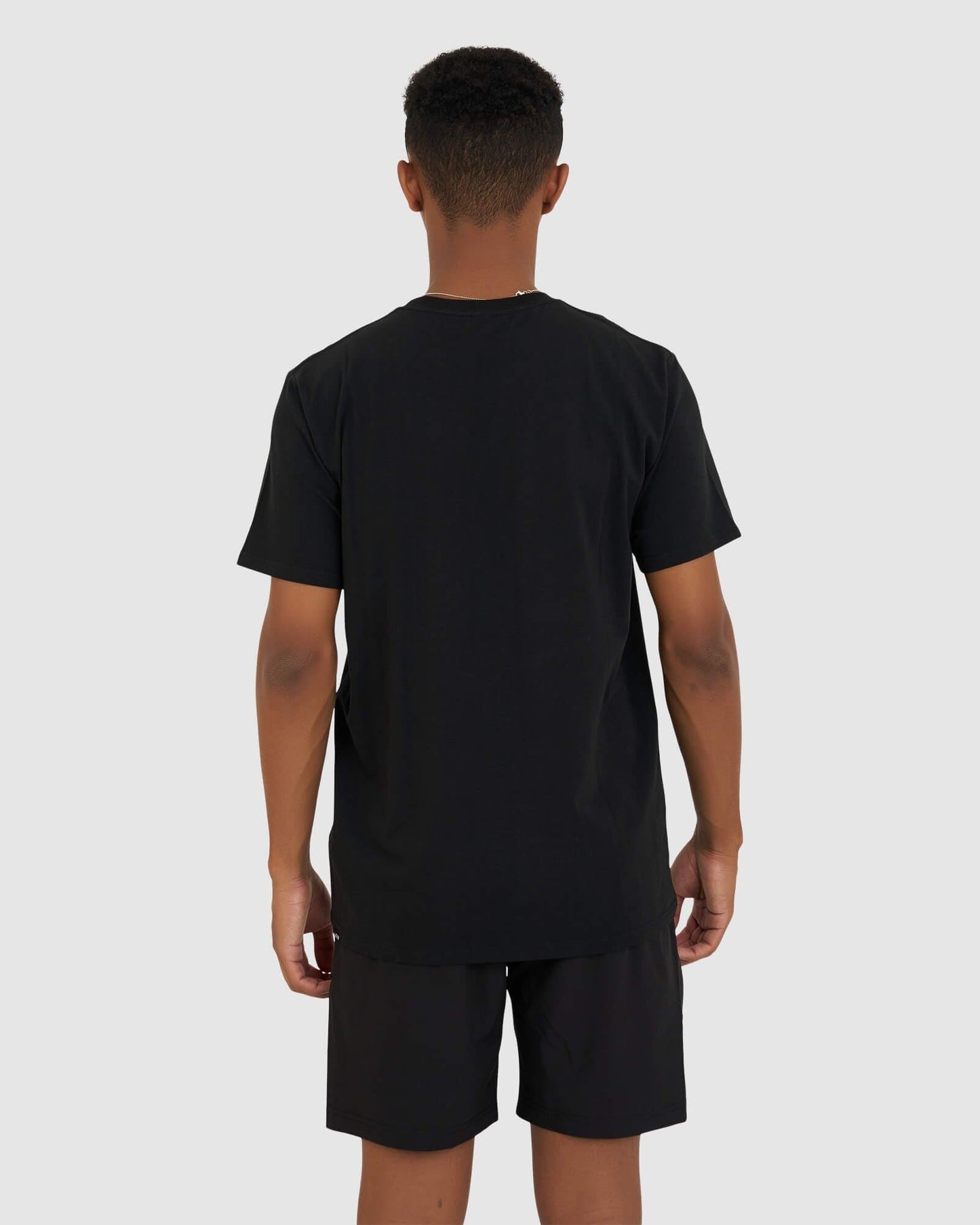 Model wearing Base Tee - Black