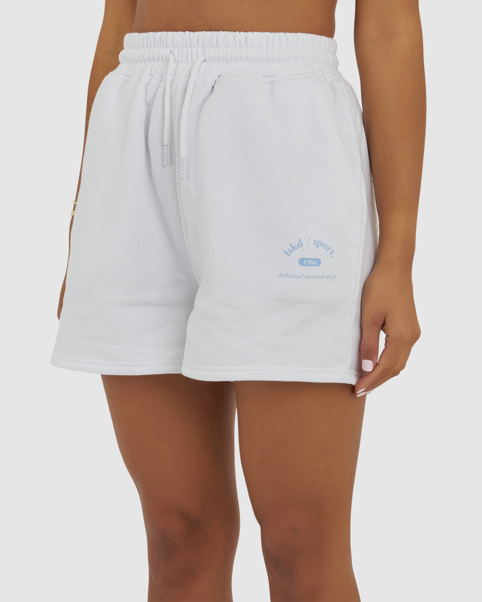 Model wearing Unisex 1986 Short - White