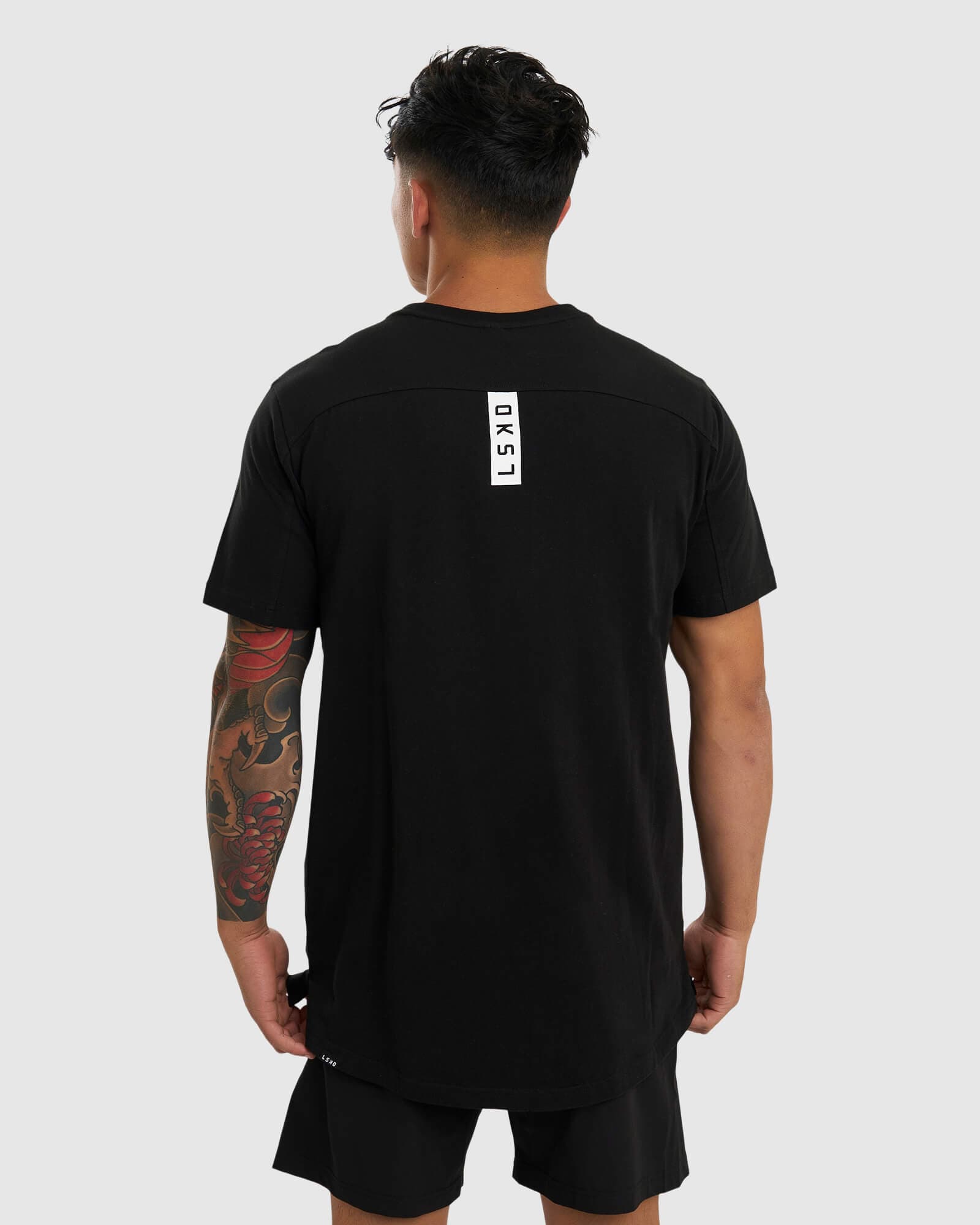 Model wearing Tab Tee - Black