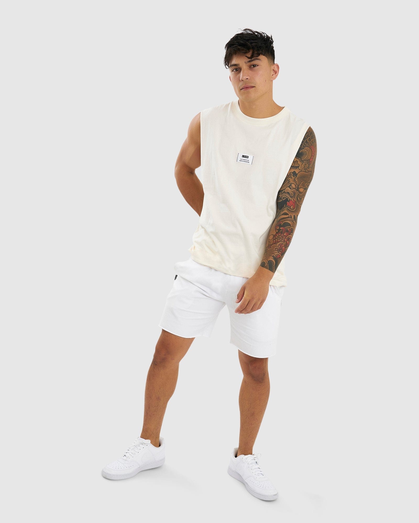 Model wearing Merch Tank Vintage Fit - Cream