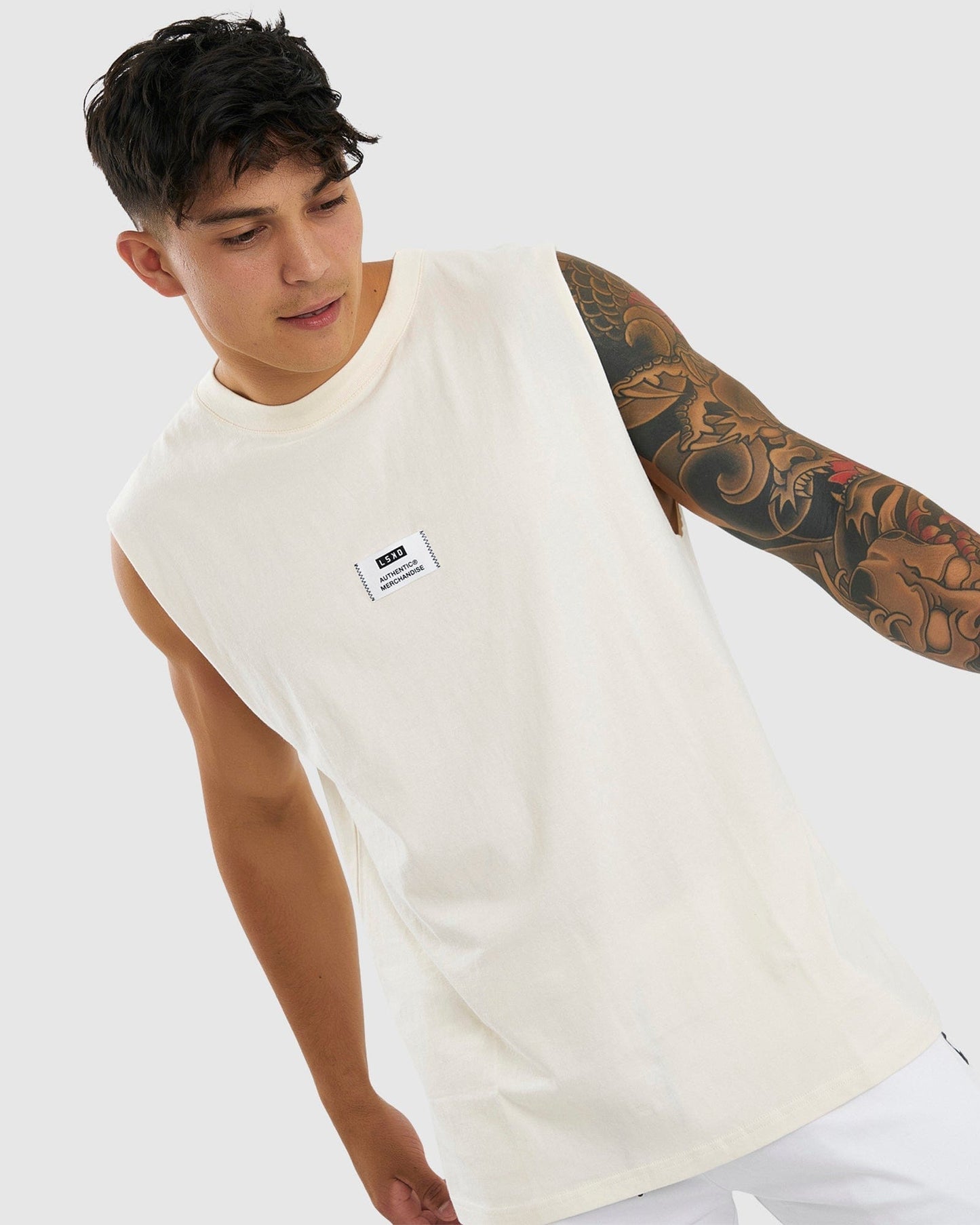 Model wearing Merch Tank Vintage Fit - Cream