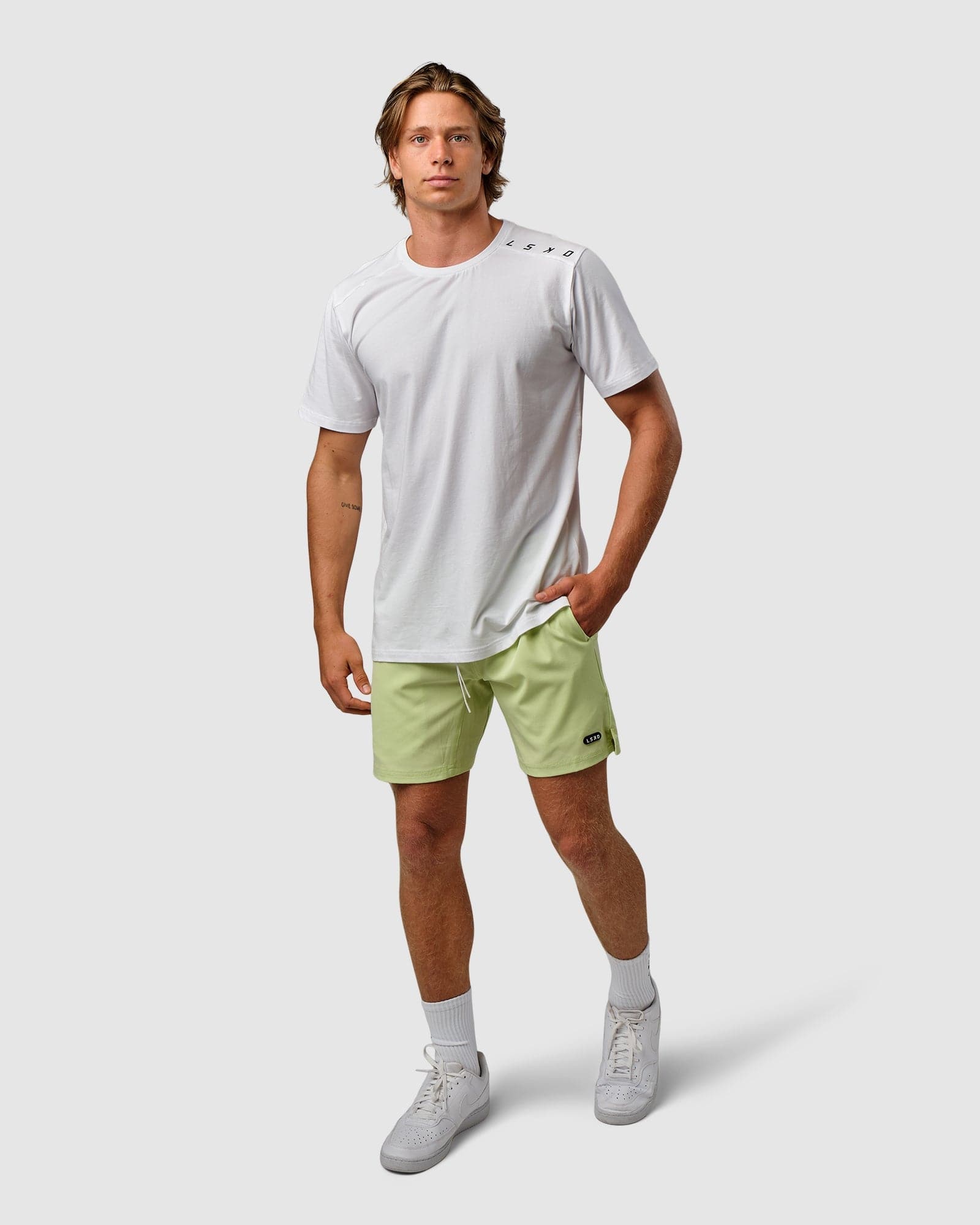 Model wearing Competitor Tee - White