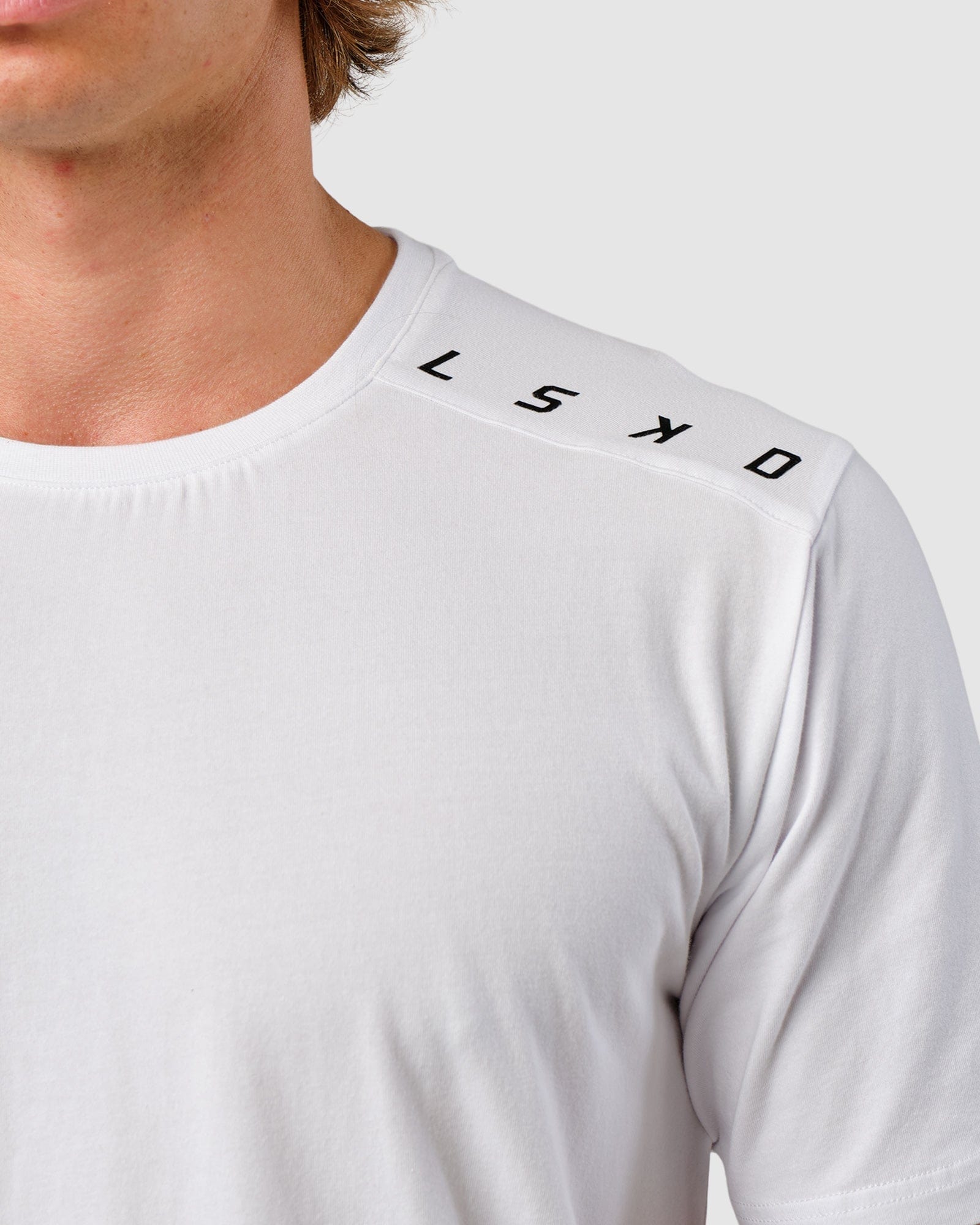 Model wearing Competitor Tee - White