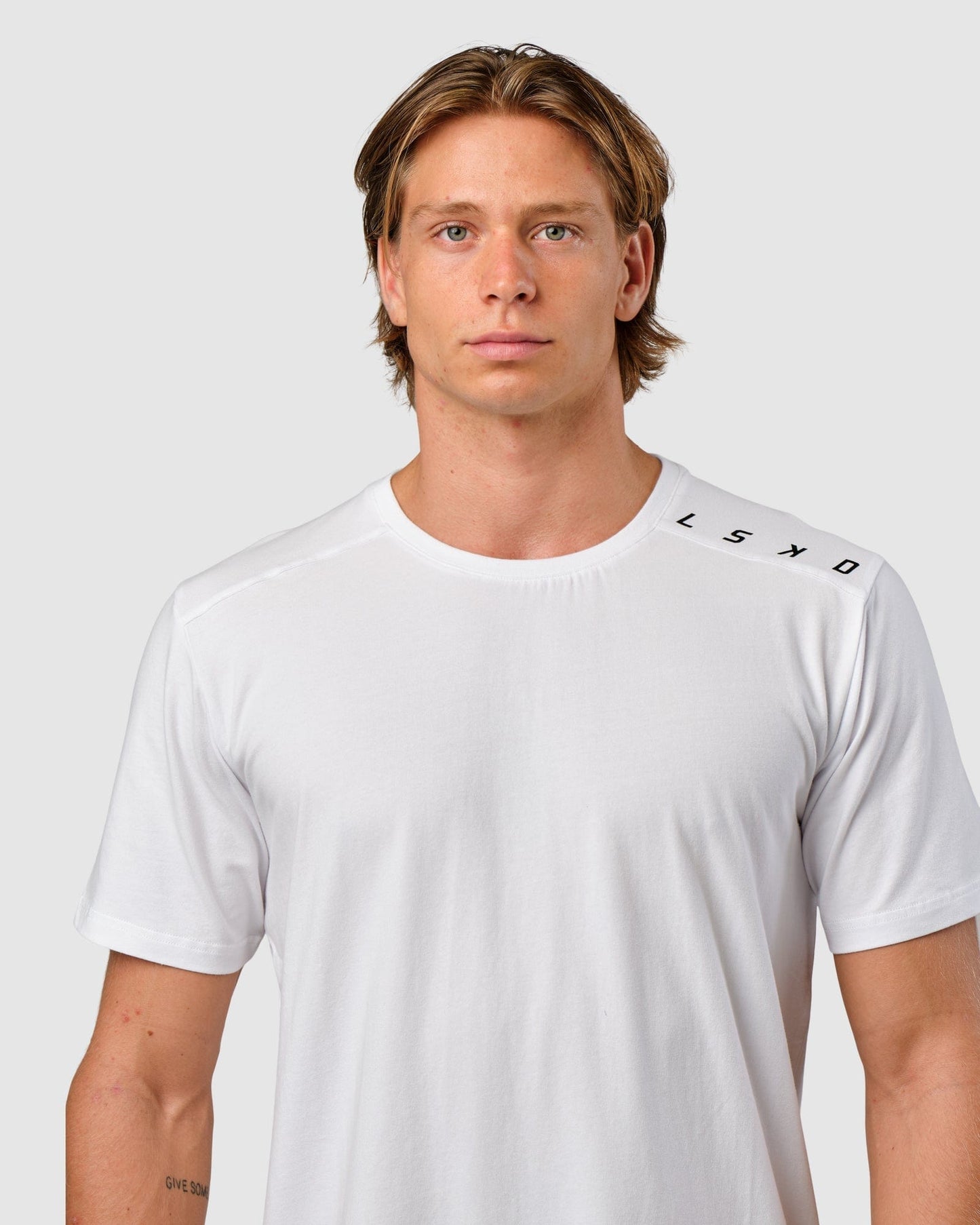 Model wearing Competitor Tee - White