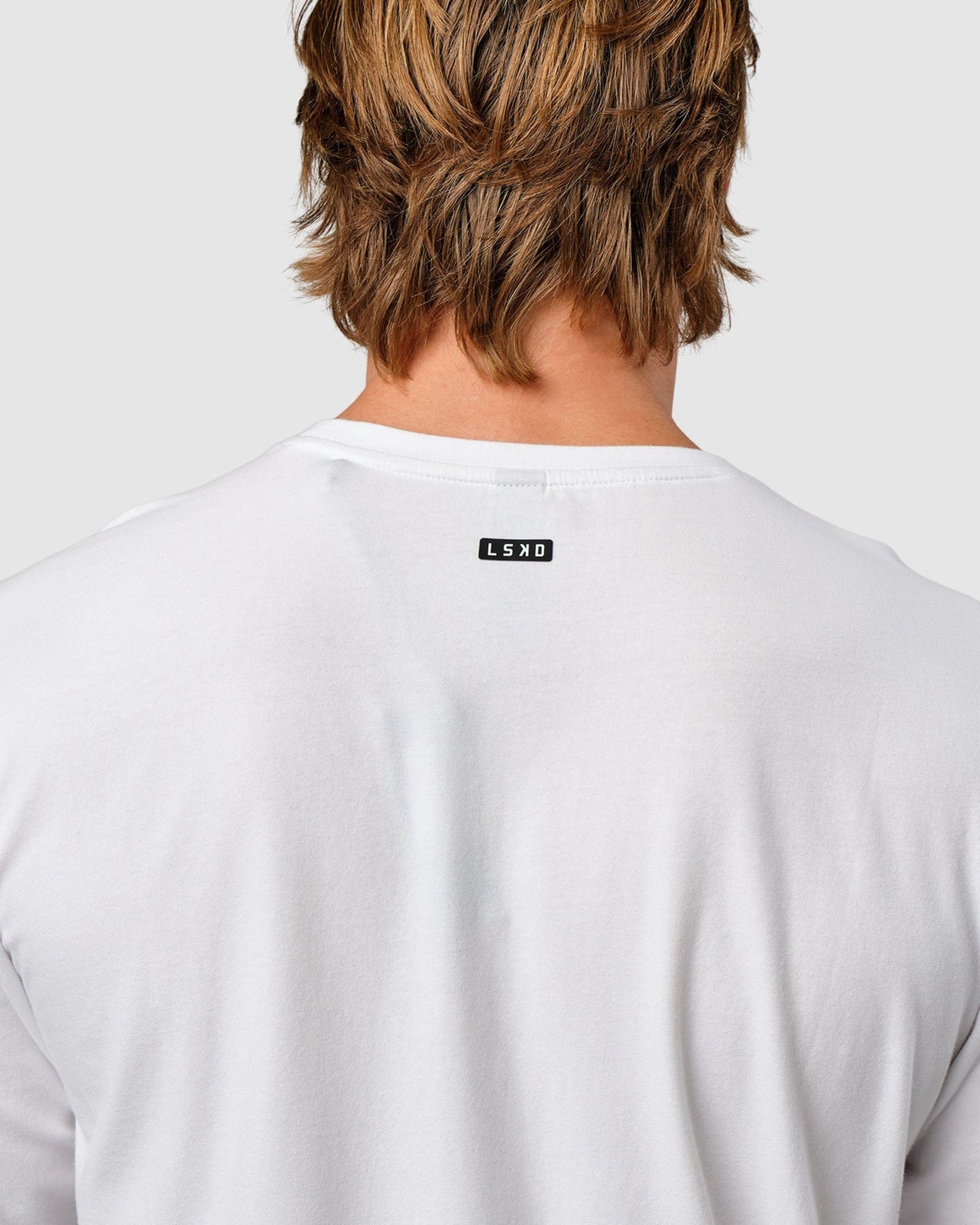 Model wearing Competitor LS Tee - White