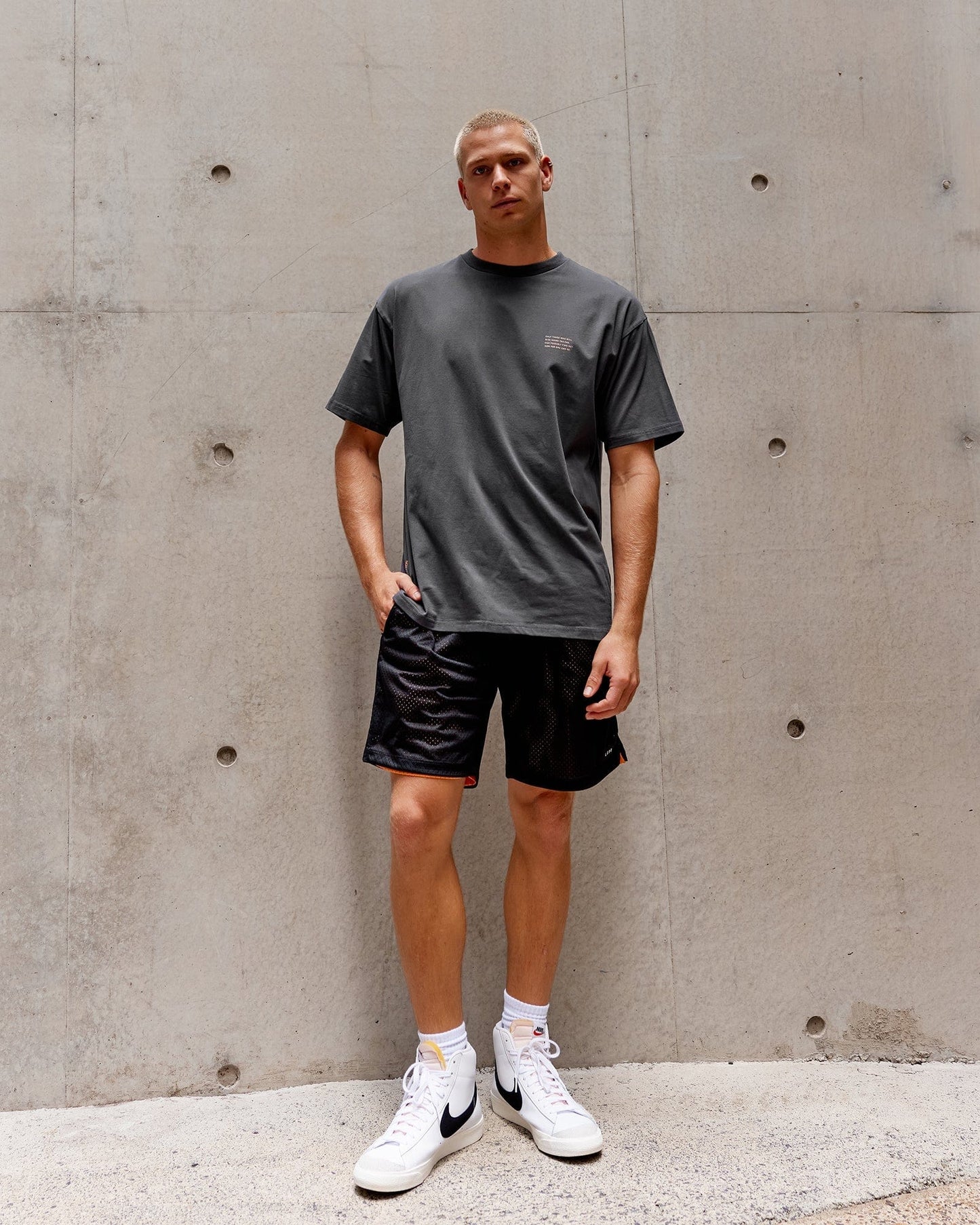 Model wearing Strive FLXCotton Tee Oversize - Asphalt-Tangerine