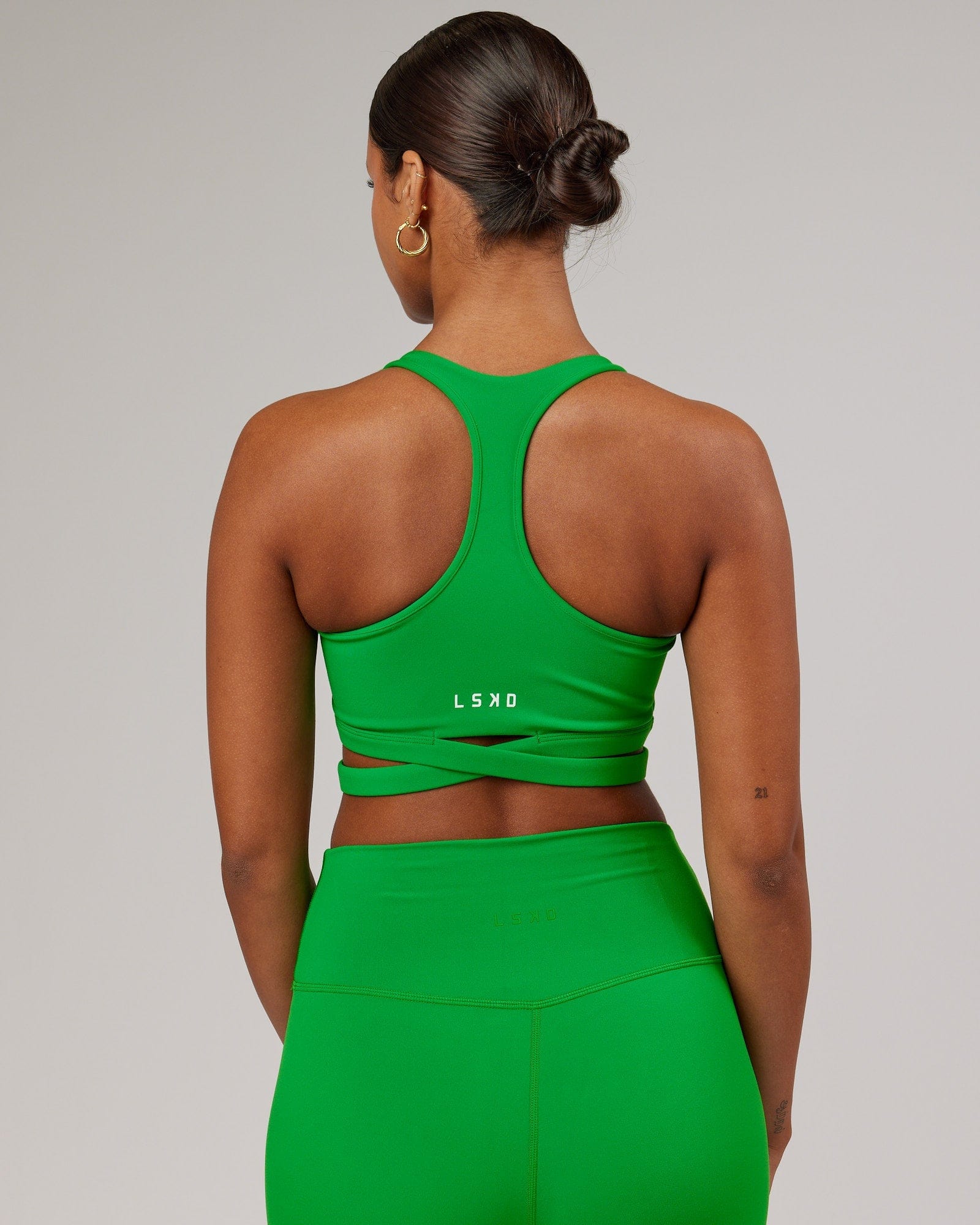 Model wearing Force Sports Bra - Vivid Green