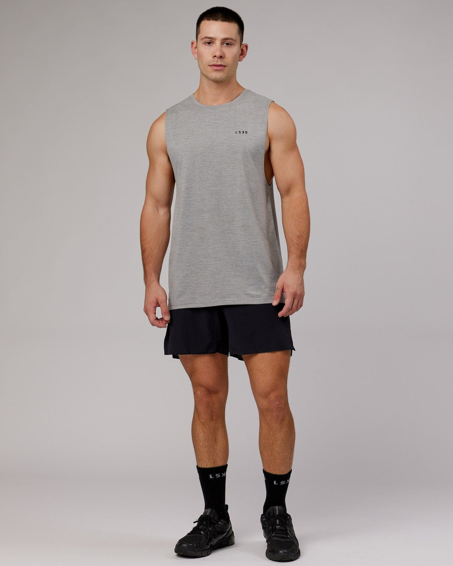Model wearing Perform VapourFLX Muscle Tank - Light Grey Marl