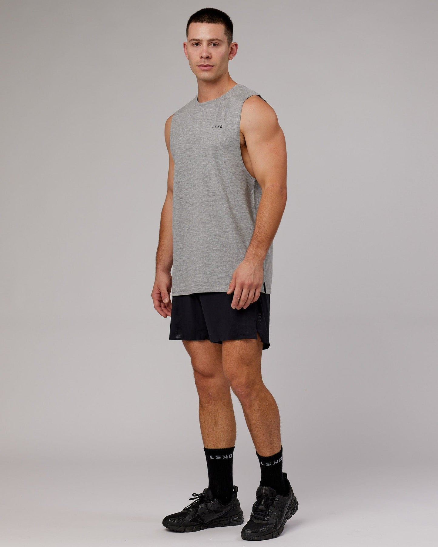 Model wearing Perform VapourFLX Muscle Tank - Light Grey Marl