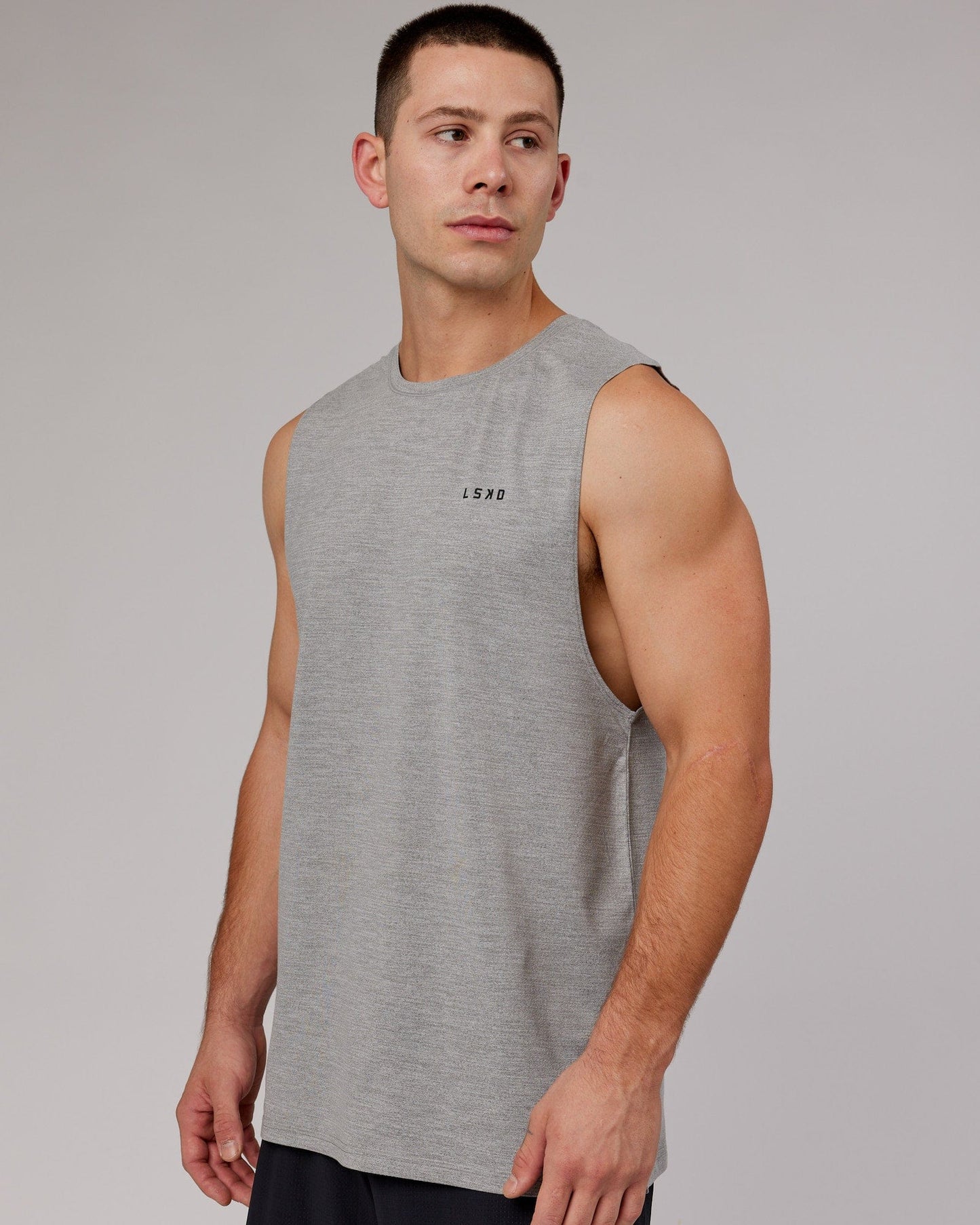 Model wearing Perform VapourFLX Muscle Tank - Light Grey Marl