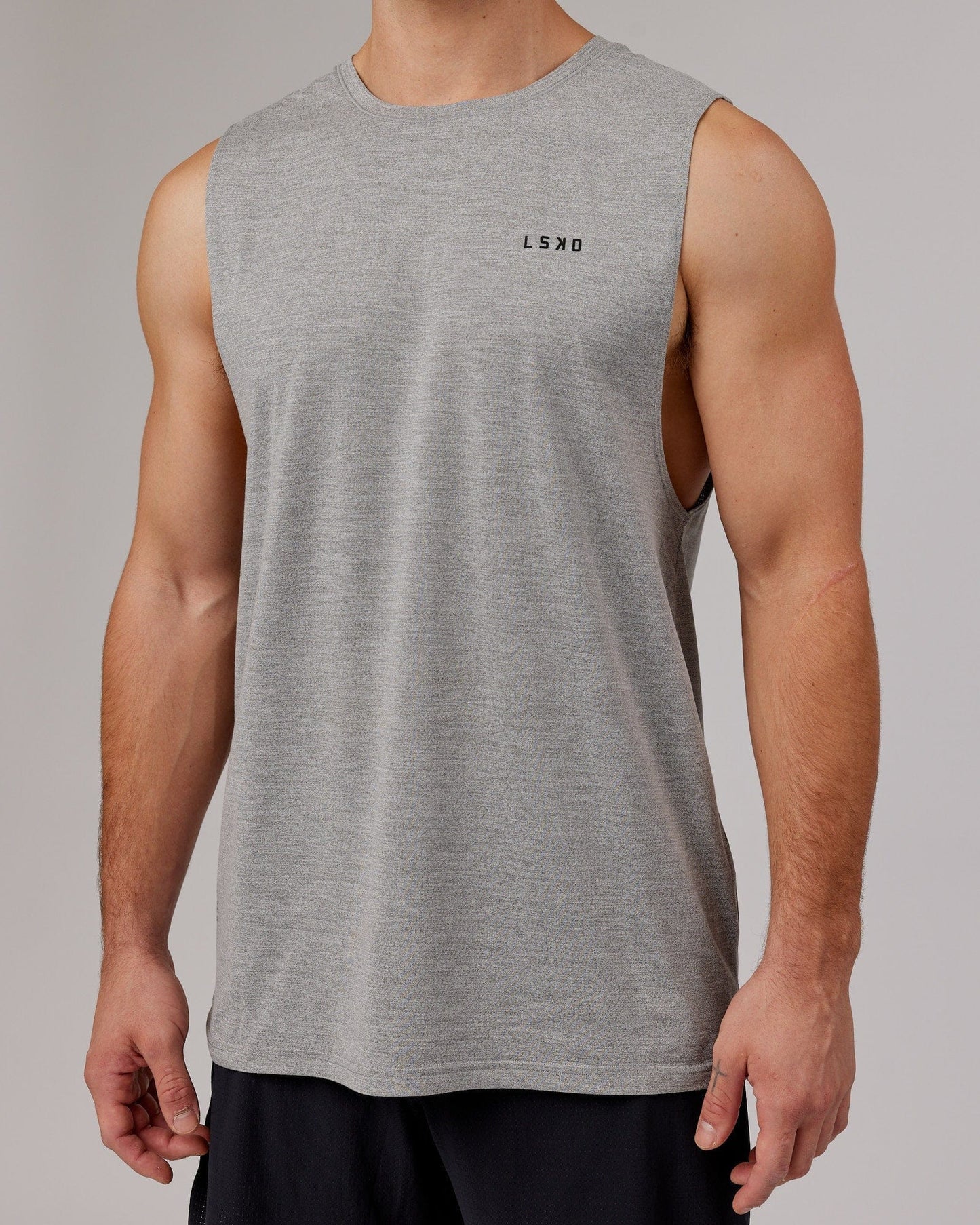 Model wearing Perform VapourFLX Muscle Tank - Light Grey Marl