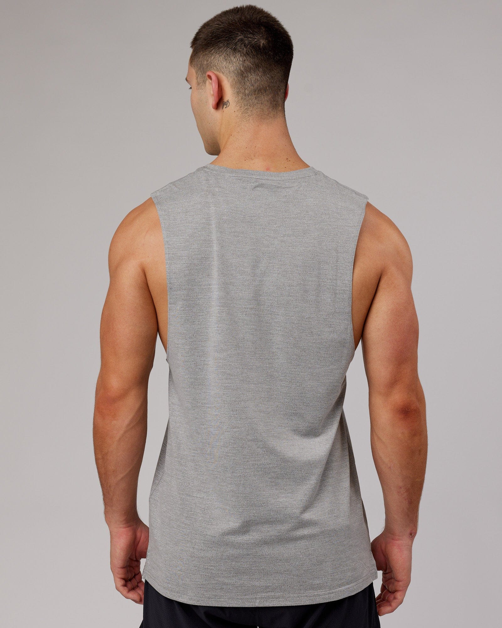Model wearing Perform VapourFLX Muscle Tank - Light Grey Marl