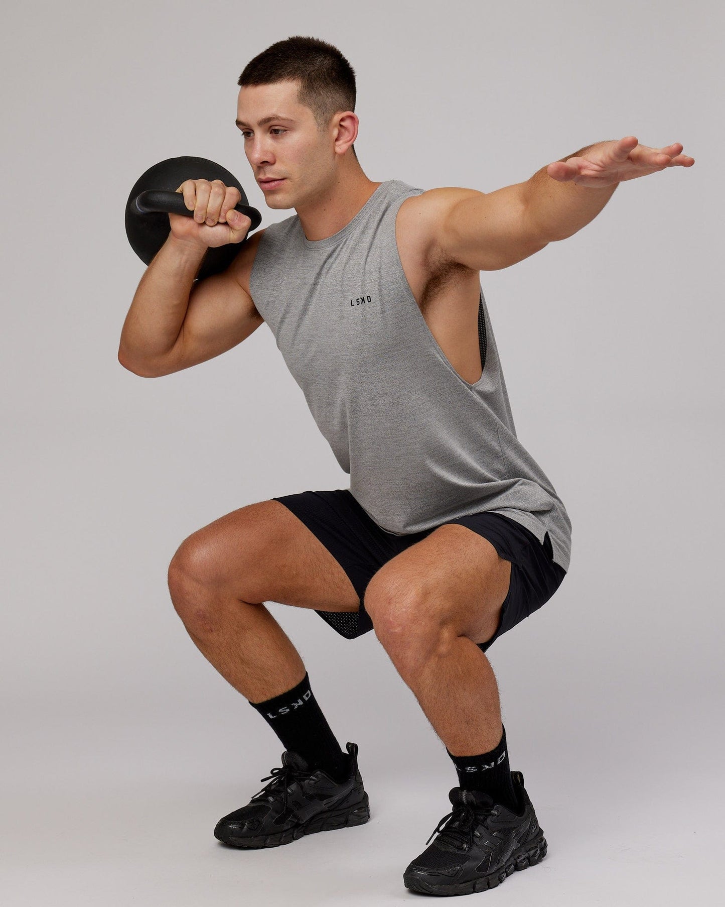 Model wearing Perform VapourFLX Muscle Tank - Light Grey Marl