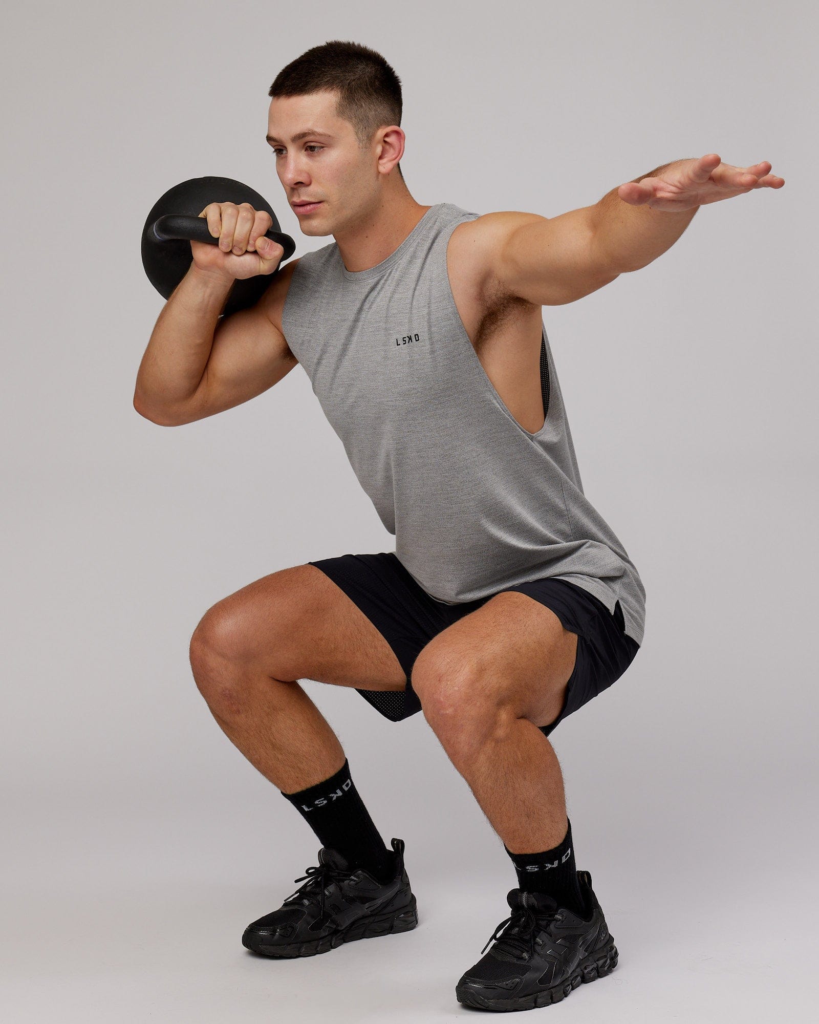 Model wearing Perform VapourFLX Muscle Tank - Light Grey Marl