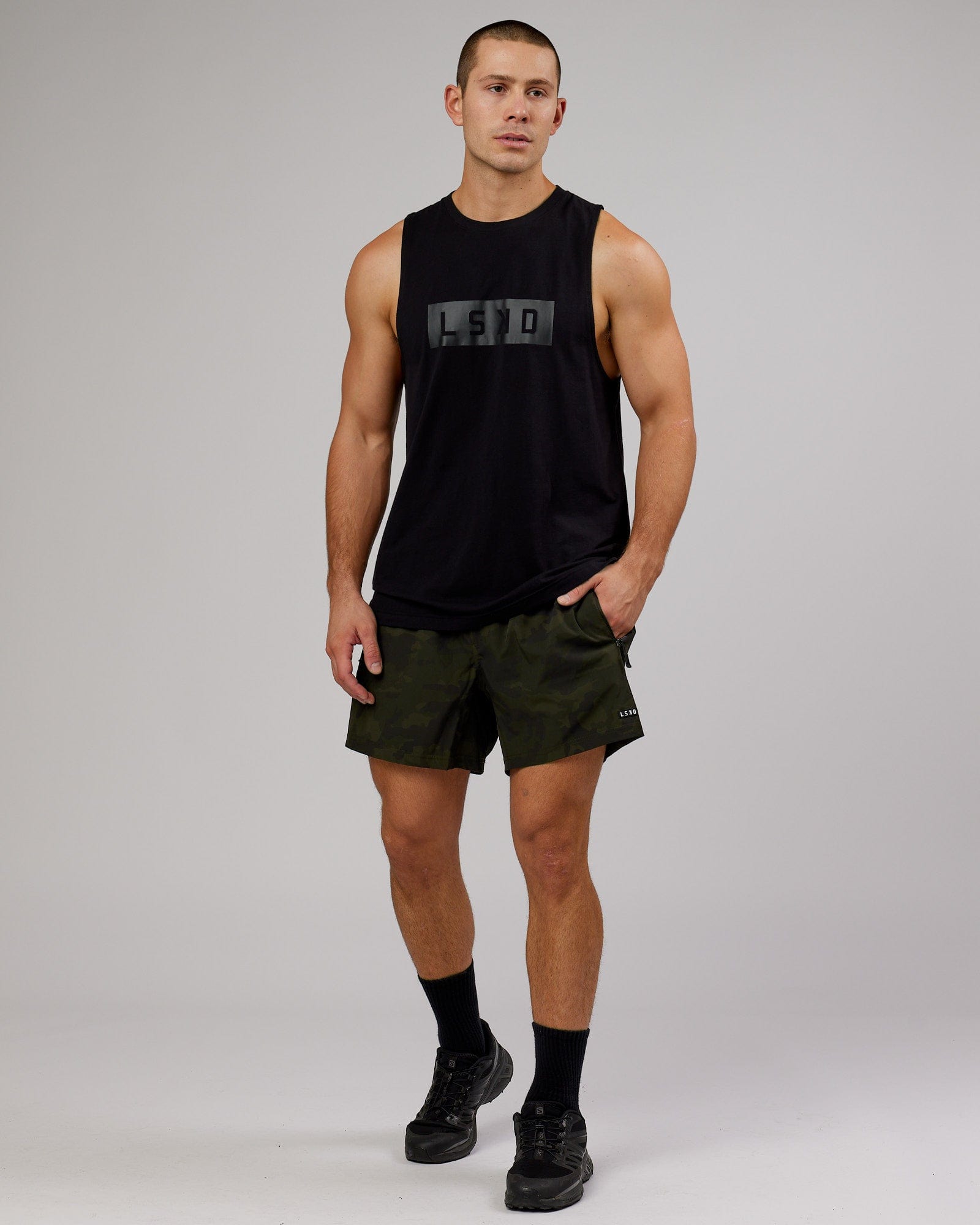 Model wearing Rep 5" Performance Short - Dark Olive Camo